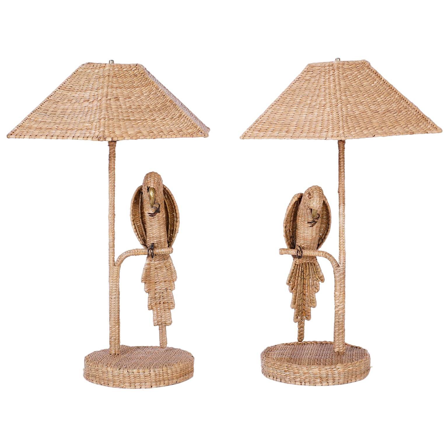 Whimsical pair of parrot or bird table lamps crafted with reed wrapped over a metal frame with a brass beak and copper eyes. Signed Mario Torres on a brass medallion and your choice of a wicker or linen shade.