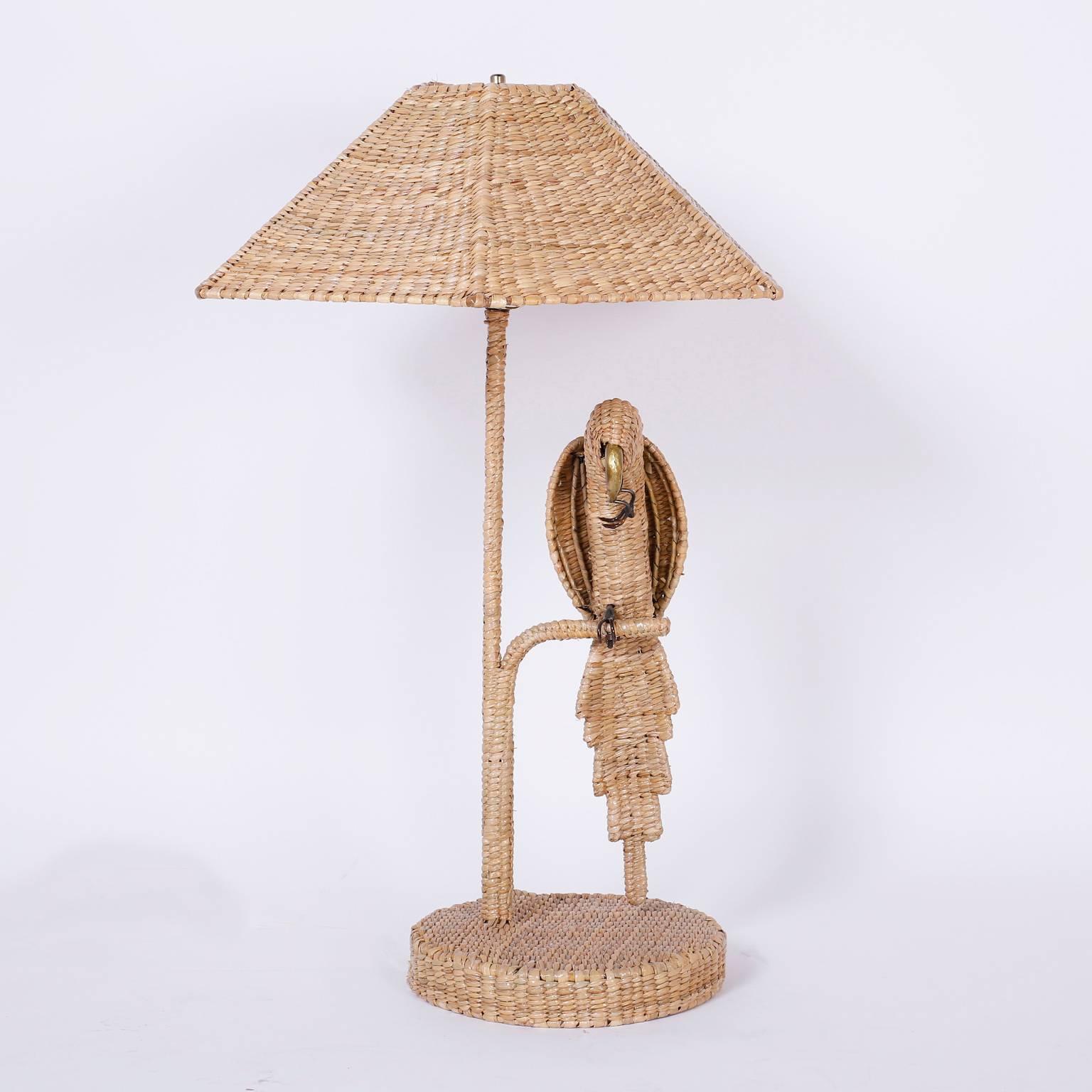 Whimsical pair of parrot or bird table lamps crafted with reed wrapped over a metal frame with a brass beak and copper eyes. Signed Mario Torres on a brass medallion and your choice of a wicker or linen shade.