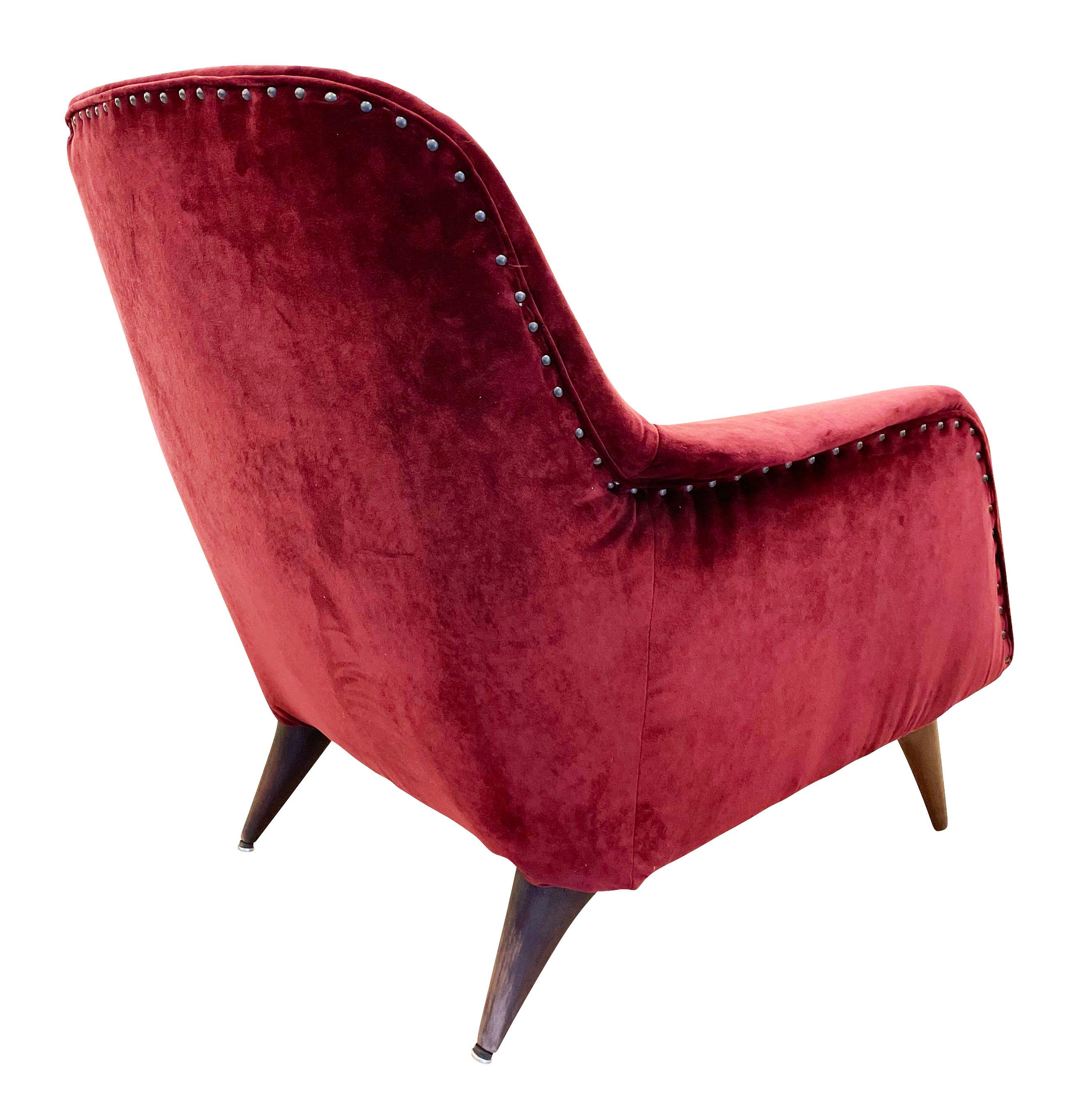 Italian Mid-Century lounge chairs with aerodynamic lines inspired by the futuristic high speed trains and planes of the time. Dark wood legs. Recovered in a maroon velvet.

Condition: Minor wear consistent with age and use.

Measures: Width: