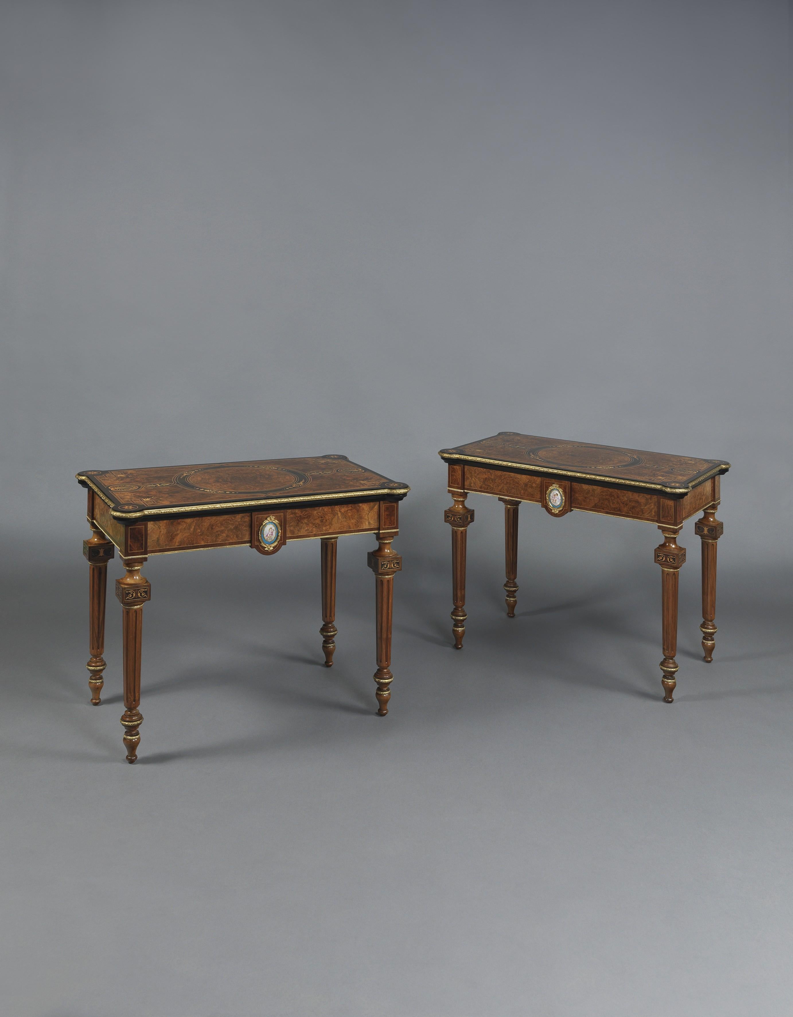 A fine pair of gilt-bronze mounted Marquetry inlaid card tables with Sèvres-style porcelain plaques.

English, circa 1870. 

Each table has a rectangular fold over top with lobed corners, finely inlaid with floral bands and stylised scallop