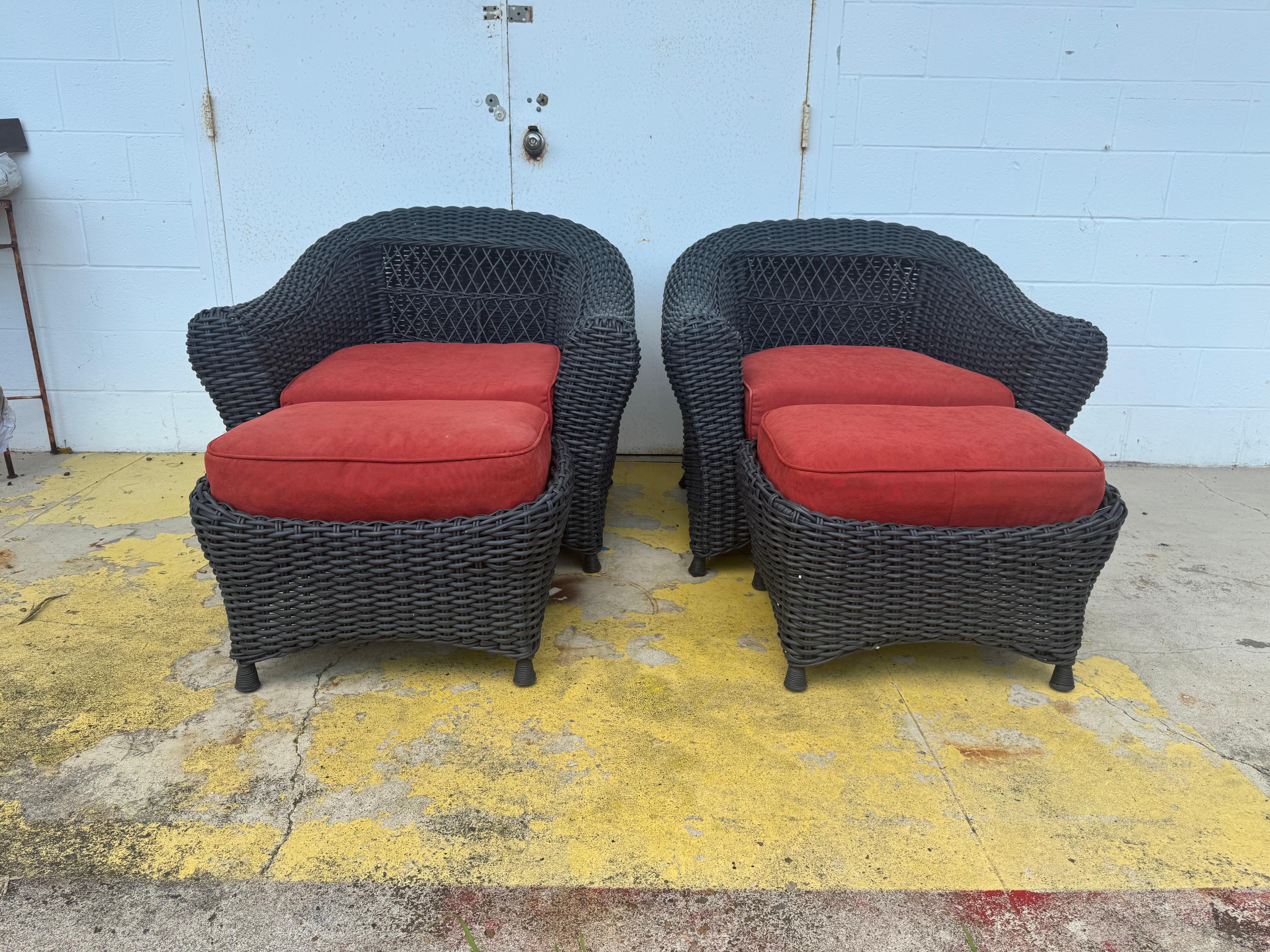 A pair of charcoal wicker chairs by Martha Stewart. These chairs feature intricate wicker weaving. The chairs are labeled and exhibit the classic design elements associated with Martha Stewart. 
Dimensions:
Width: 36