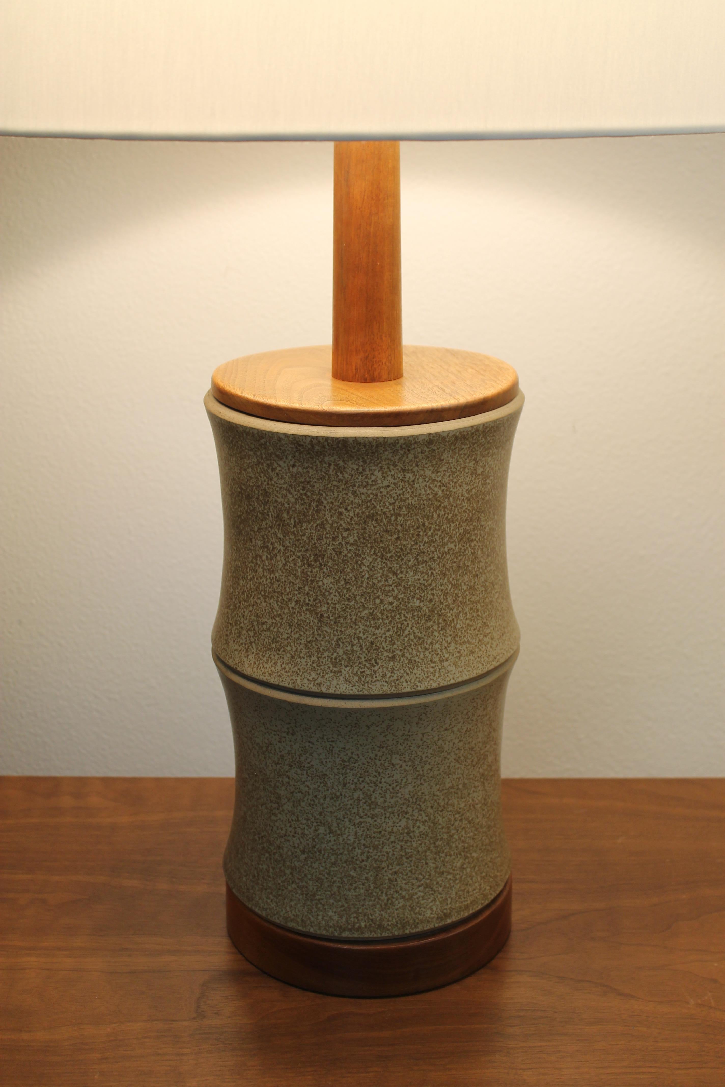 Pair of ceramic and wood Martz Lamps. Lamps have original finials and have been professionally rewired. Lamps measure 21
