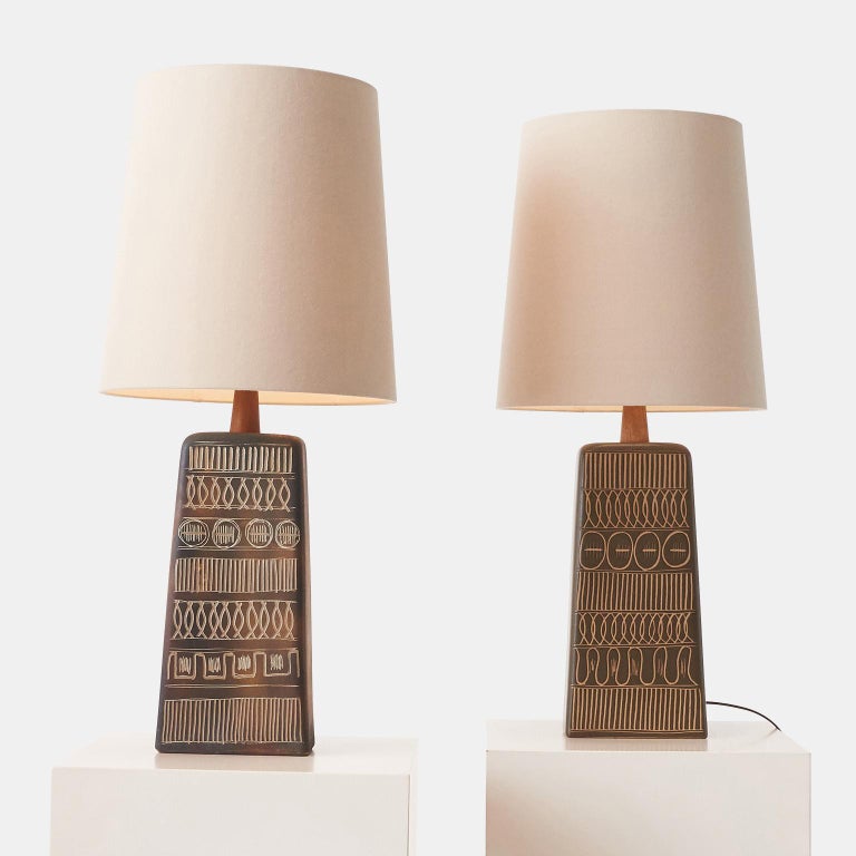 A beautiful pair of large earth colored stoneware table lamps by Jane & Gordon Martz for Marshall Studios. Each lamp is decorated by hand by incising the through the glaze to the tan clay. Etched “Martz” on the back.

Complete with beautiful