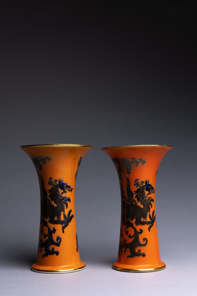 A pair of trumpet vases in the ‘Sumatra’ dragon pattern on a striking orange glaze with cobalt chinoiserie details, made in England by Mason's Ashworth circa 1910.

The ‘Sumatra’ pattern’s bold chinoiserie aesthetic is timeless, maintaining