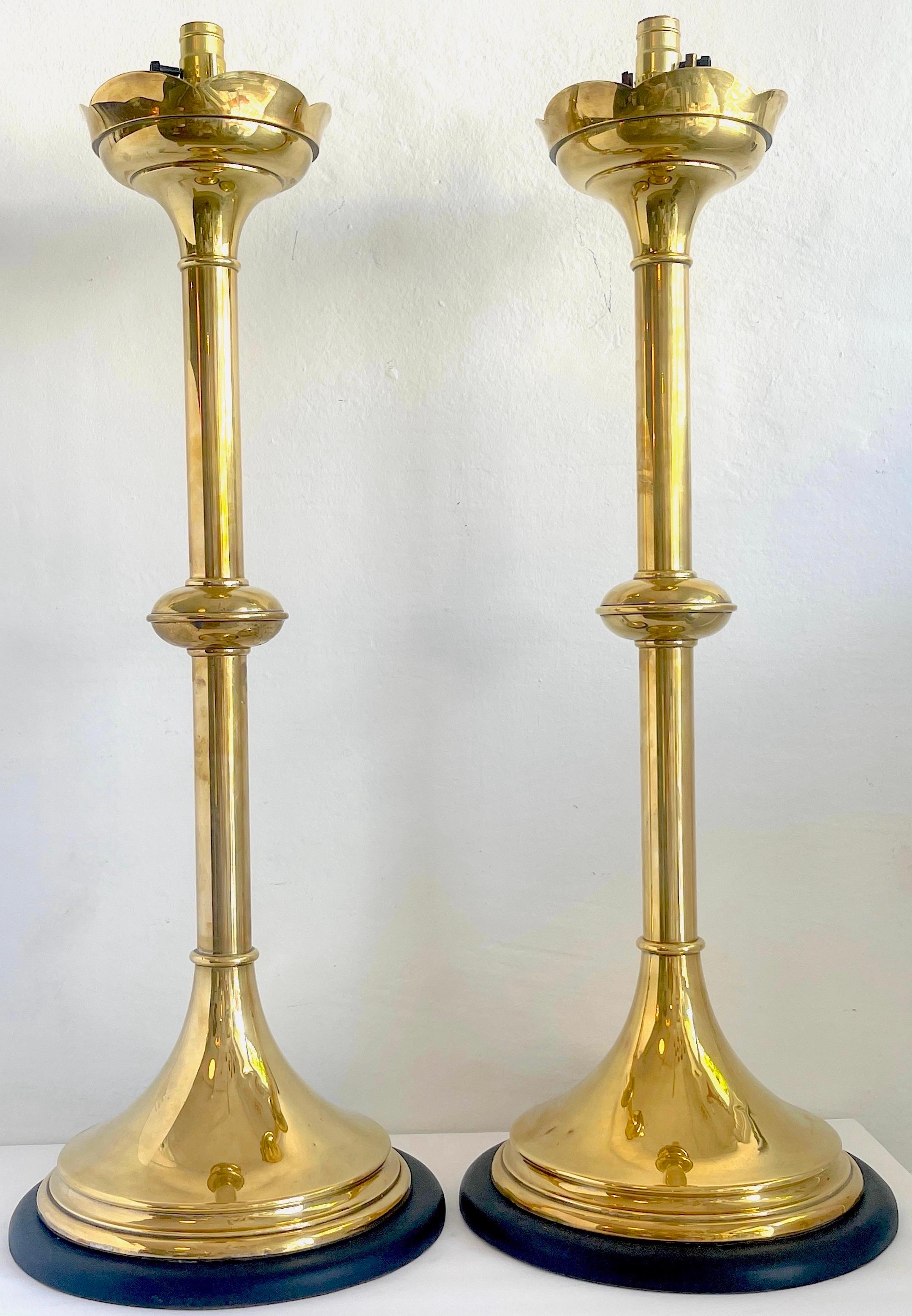 Pair of massive brass 'Trumpet' Gothic Style lamps
England, 1900s
Each one of substantial size and grace, standing 35-inches tot he socket, 32.5-Inches high to the the top of the column, resting on a 13-Inch diameter ebonized wood base. 

