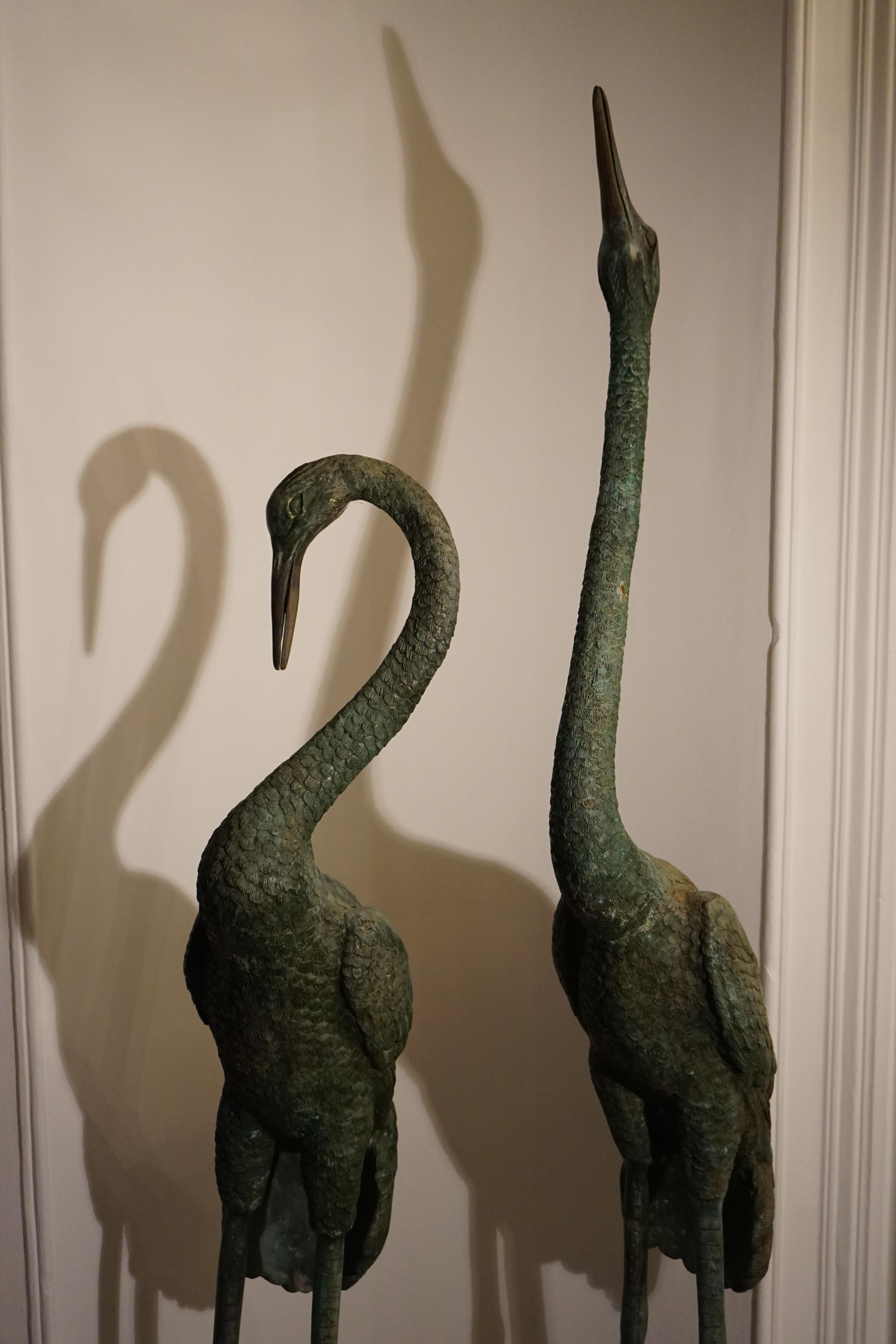 Pair of massive bronze cranes 
On a marble pedestal
Dimensions: width 45cm x length 160cm / width 45cm x length 195cm.
 