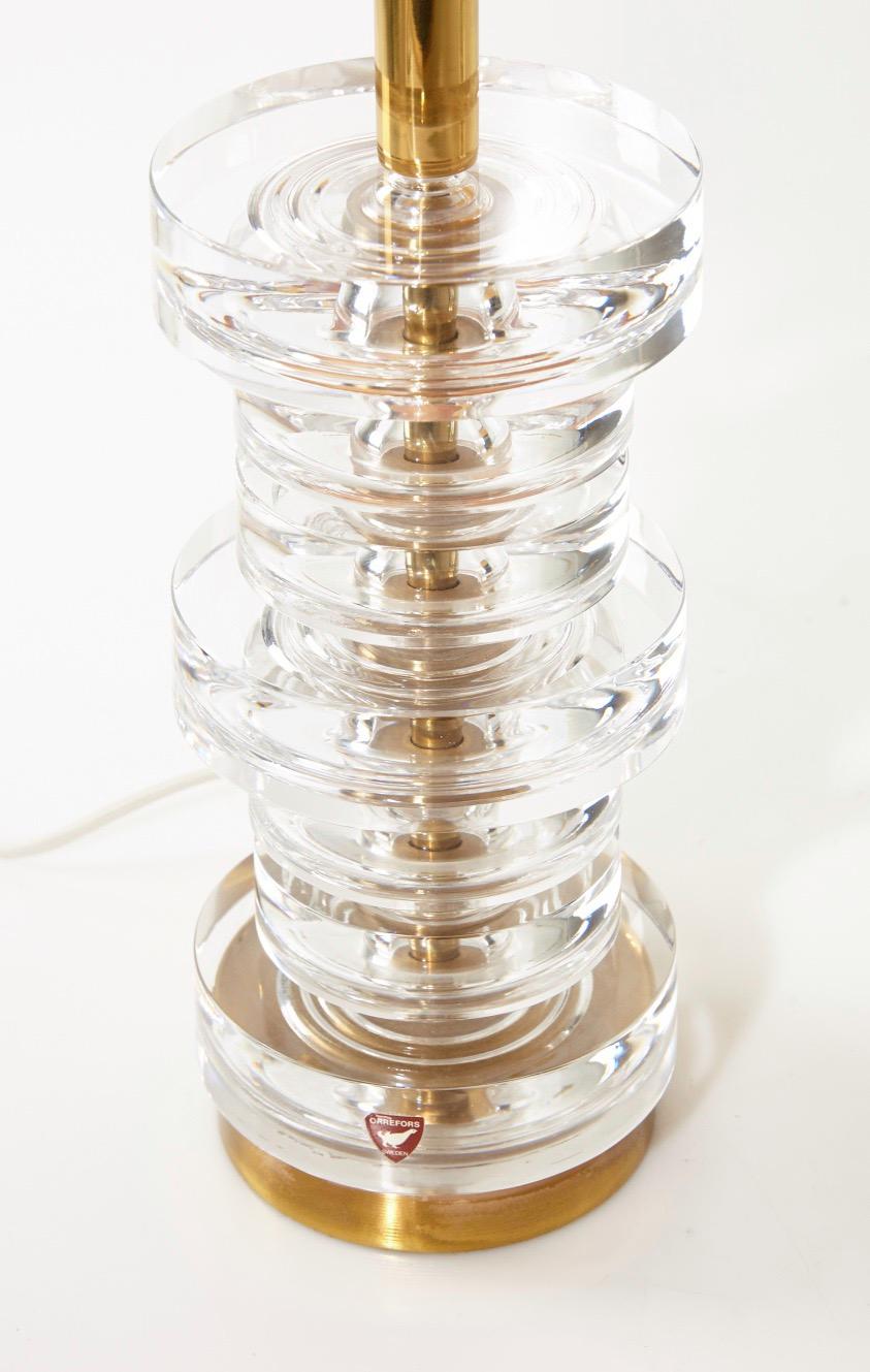 Pair of massive clear stacked crystal disc Orrefors lamps Carl Fagerlund, Sweden, 1970
Seven individual crystal discs stacked on a brass base with original Orrefors sticker holds one Edison bulb each, excellent condition.

Measurements are for