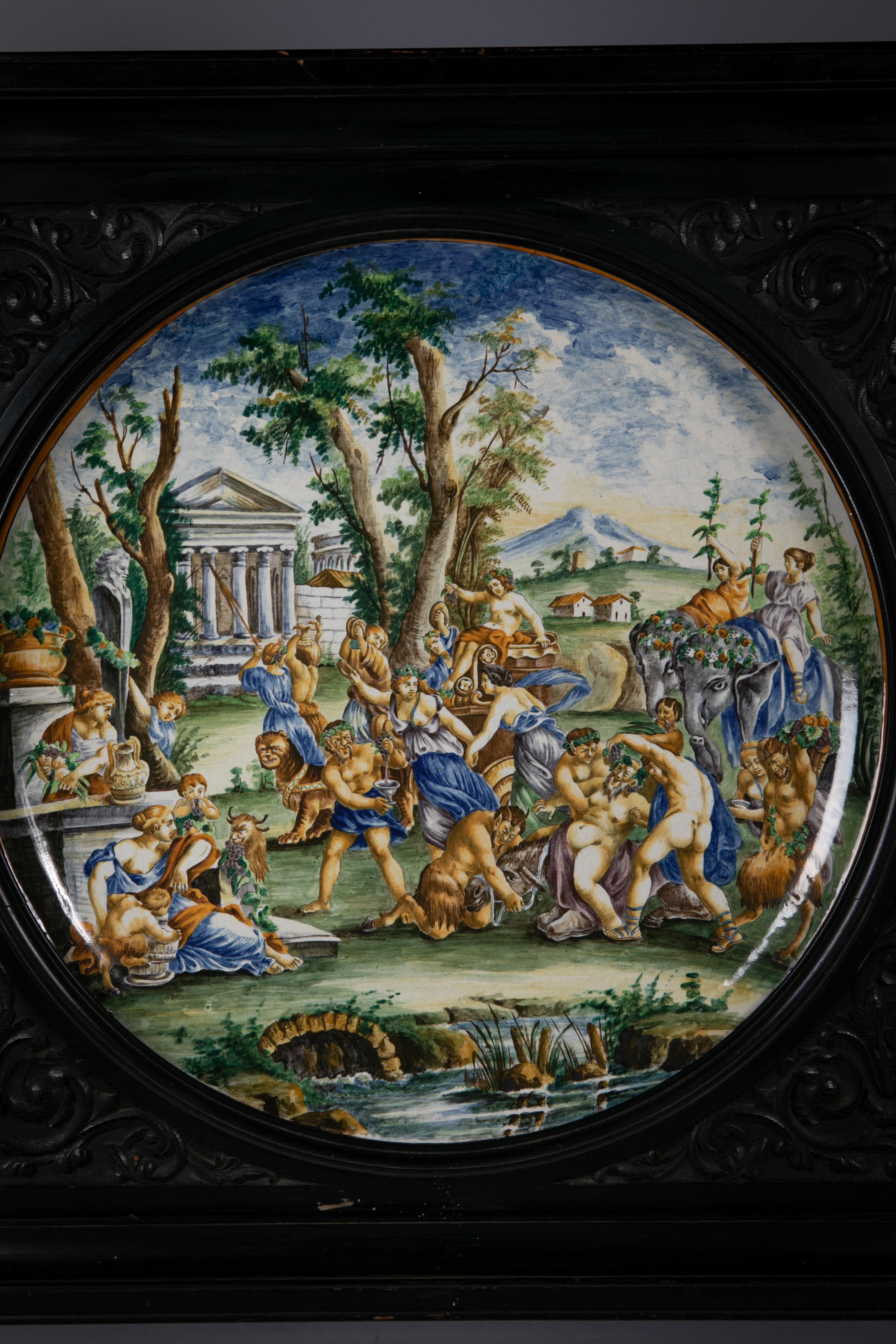 Finely painted in an Italian palette with mythological and Roman battle scenes, each border rim painted with yellow enamel. With a large carved ebony frame. Dimension of frame 34.5