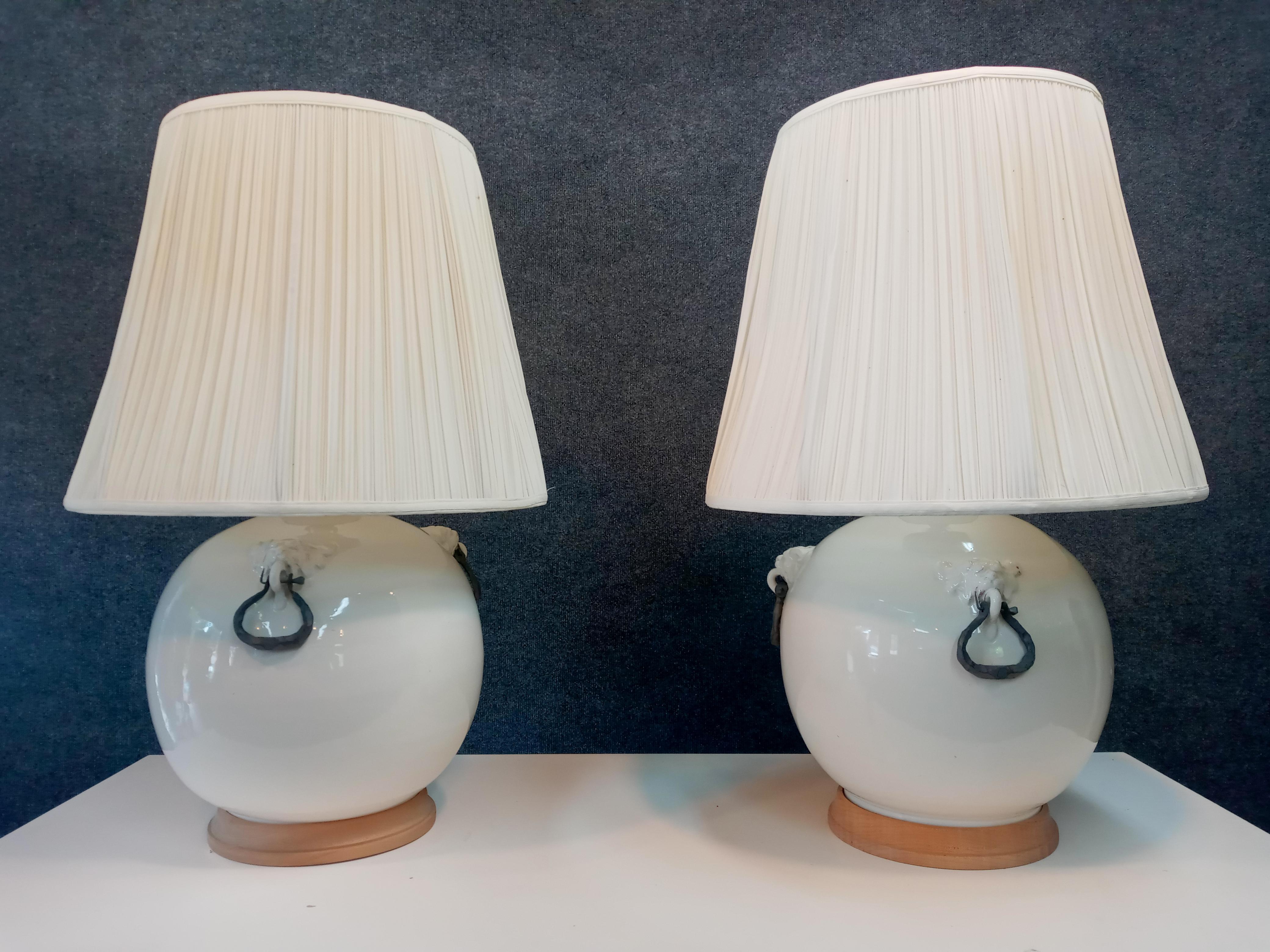 Pair of very large vintage table lamps. Glazed ceramic bodies have metal mounts, a turned wood foot, single brass socket, and original linen shades. 