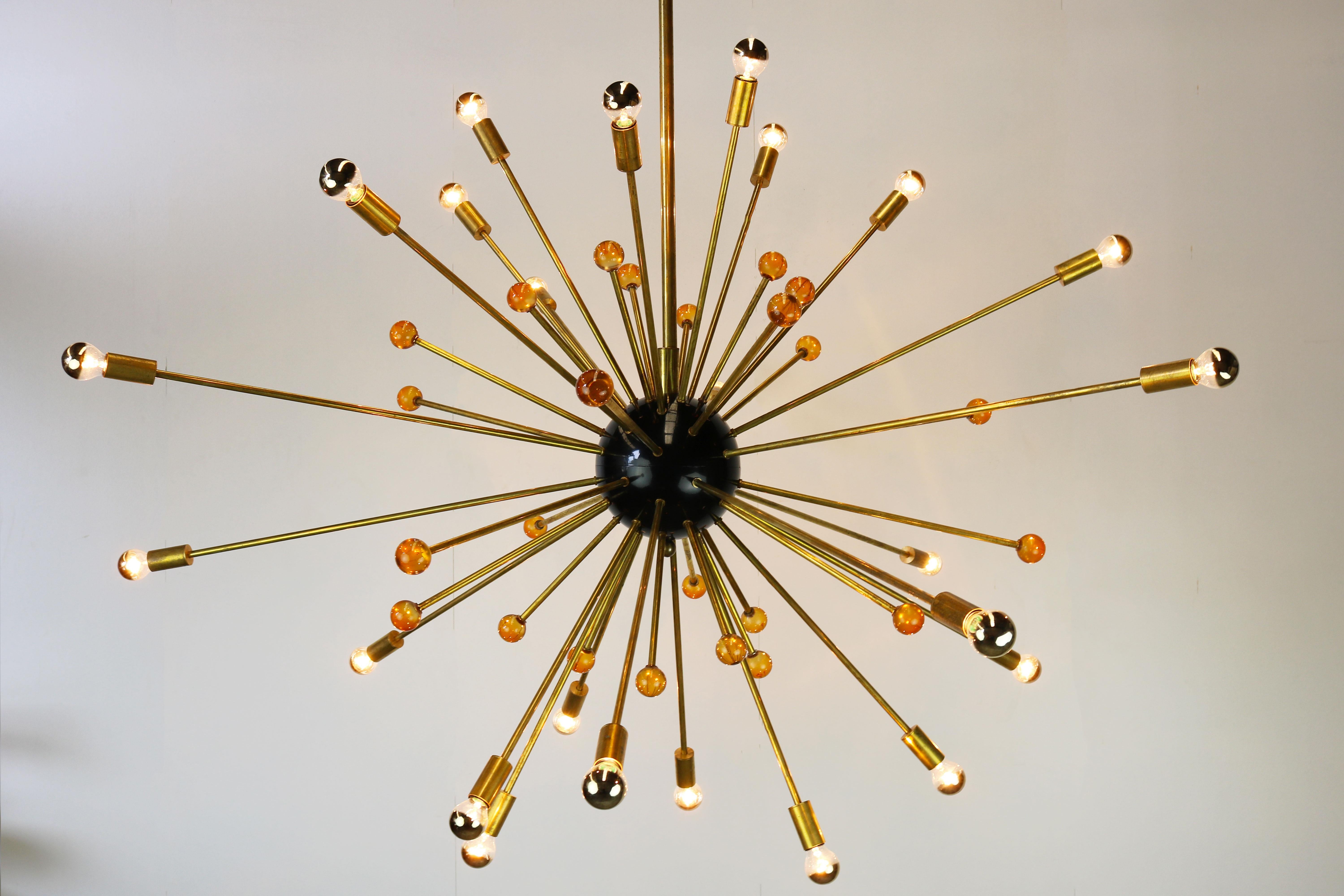 Pair of massive Sputnik chandelier Stilnovo with a diameter of 150 cm from the 1950s very large chandeliers. Each chandelier has 48 brass rods, 24 rods have a light socket and the other 24 rods have a orange glass sphere. Its Minimalistic shape make