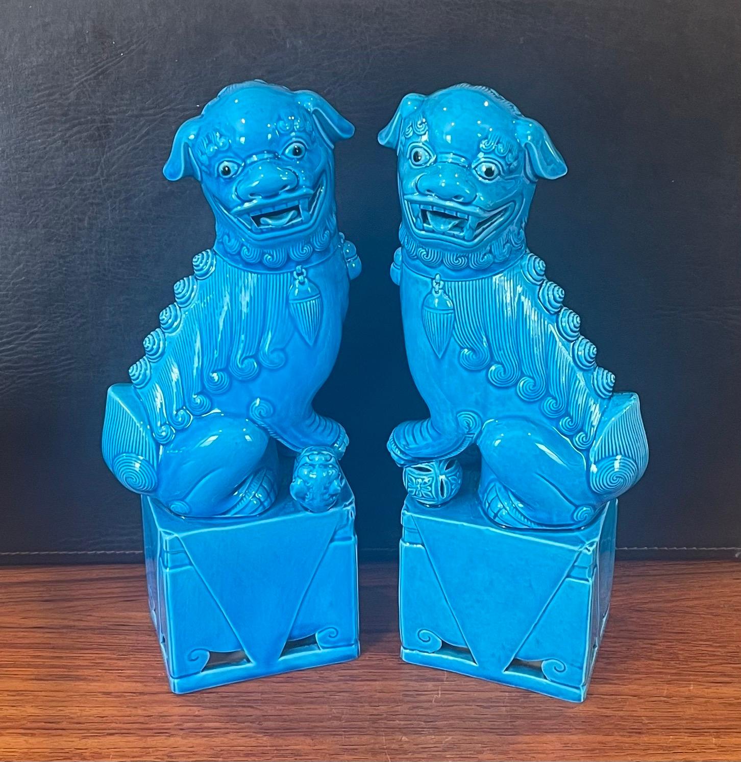 Excellent pair of massive mid-century turquoise blue ceramic foo dog sculptures, circa 1960s. These symbolic guardians present a beautiful turquoise hue and are in very good vintage condition with no chips or cracks. The dogs measure 12