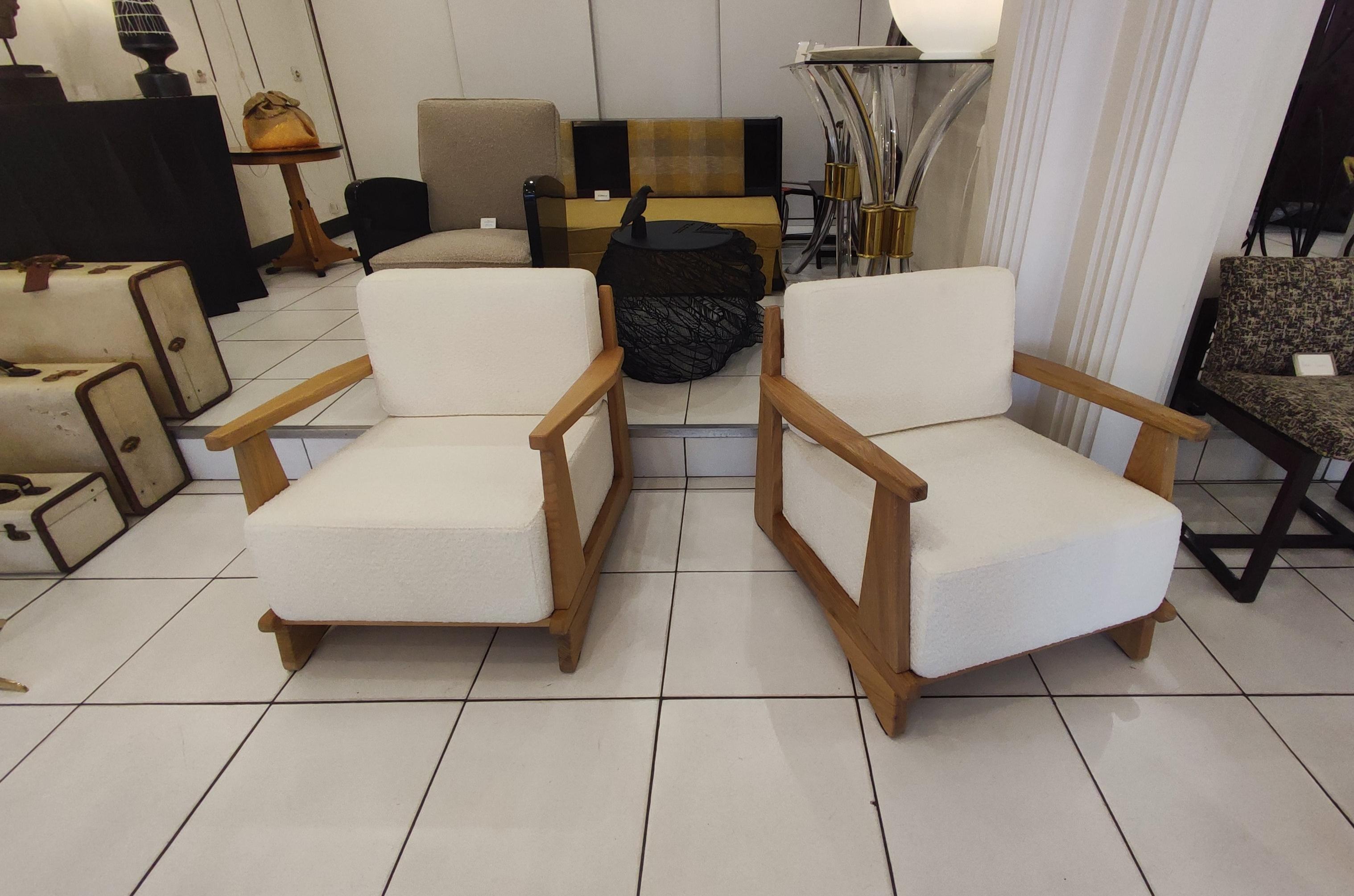 Pair of massive oak wood armchairs, Attb Maison Regain, reupholstered with white bouclette fabric.