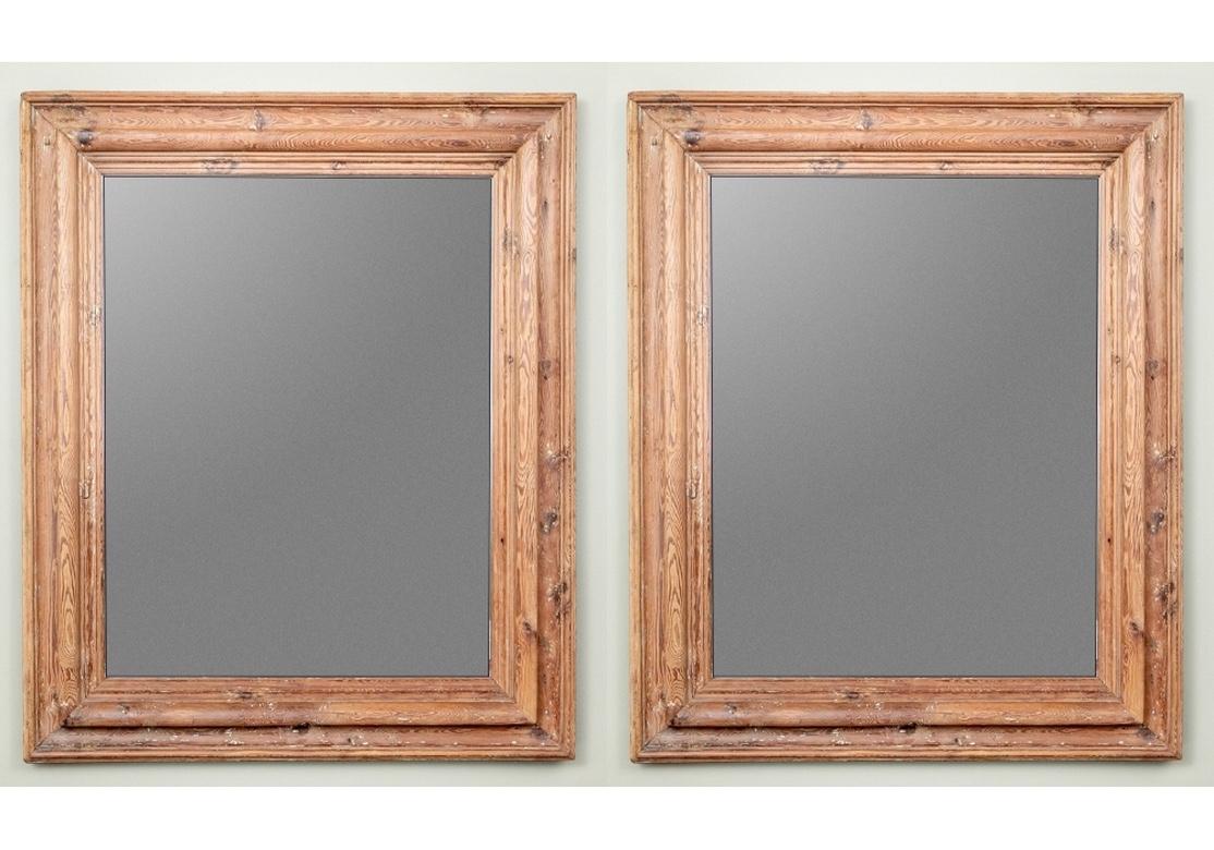 Acquired from Ralph Lauren. Massive pair of wall mirrors comprised of wood whose origin stems from an Irish castle and were repurposed to form the mirrors. The frames in an intentionally distressed finish and are extremely heavy and solid feeling.