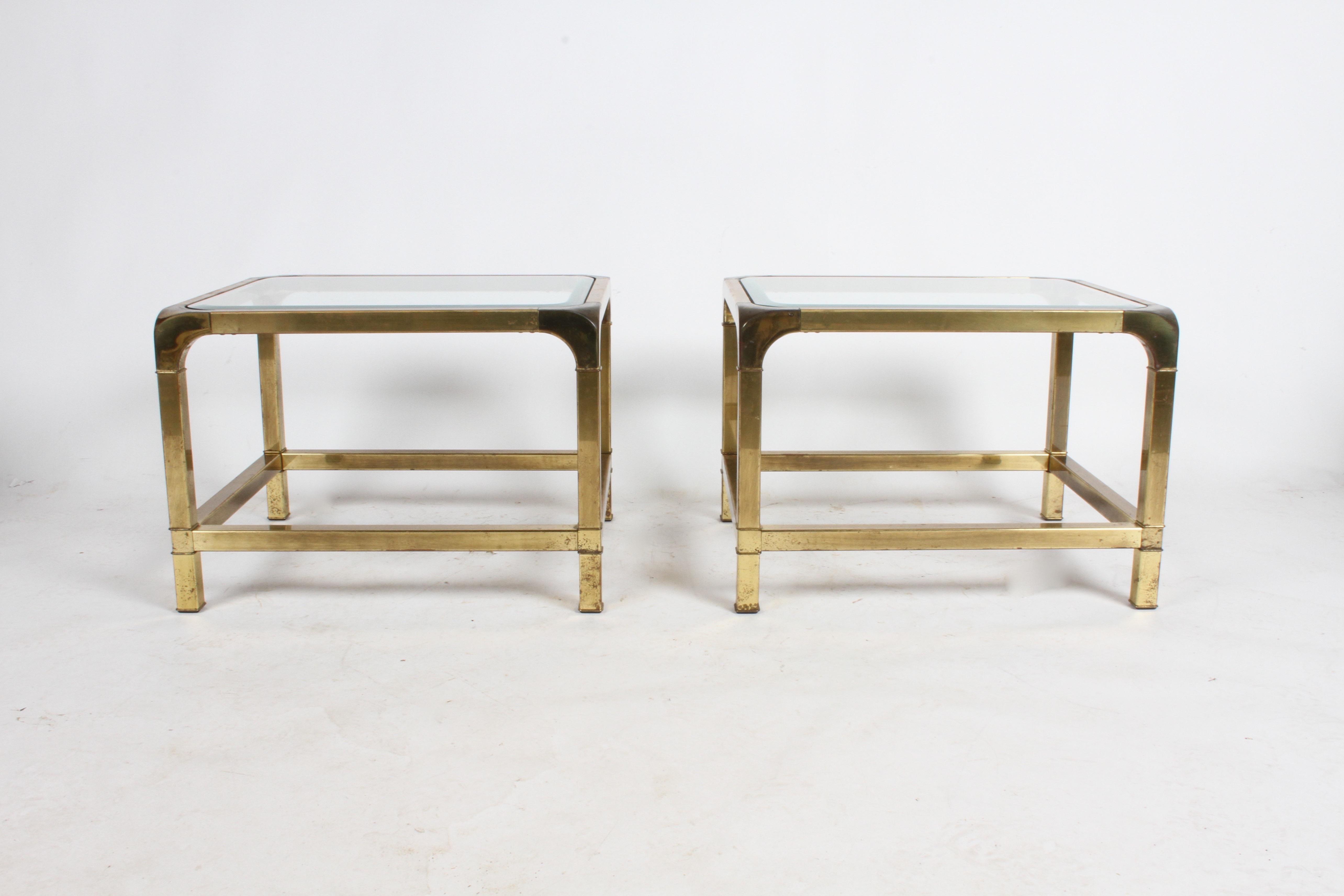 Pair of Mastercraft Asian influenced brass end tables with glass tops. Heavy patina to brass, glass has 1