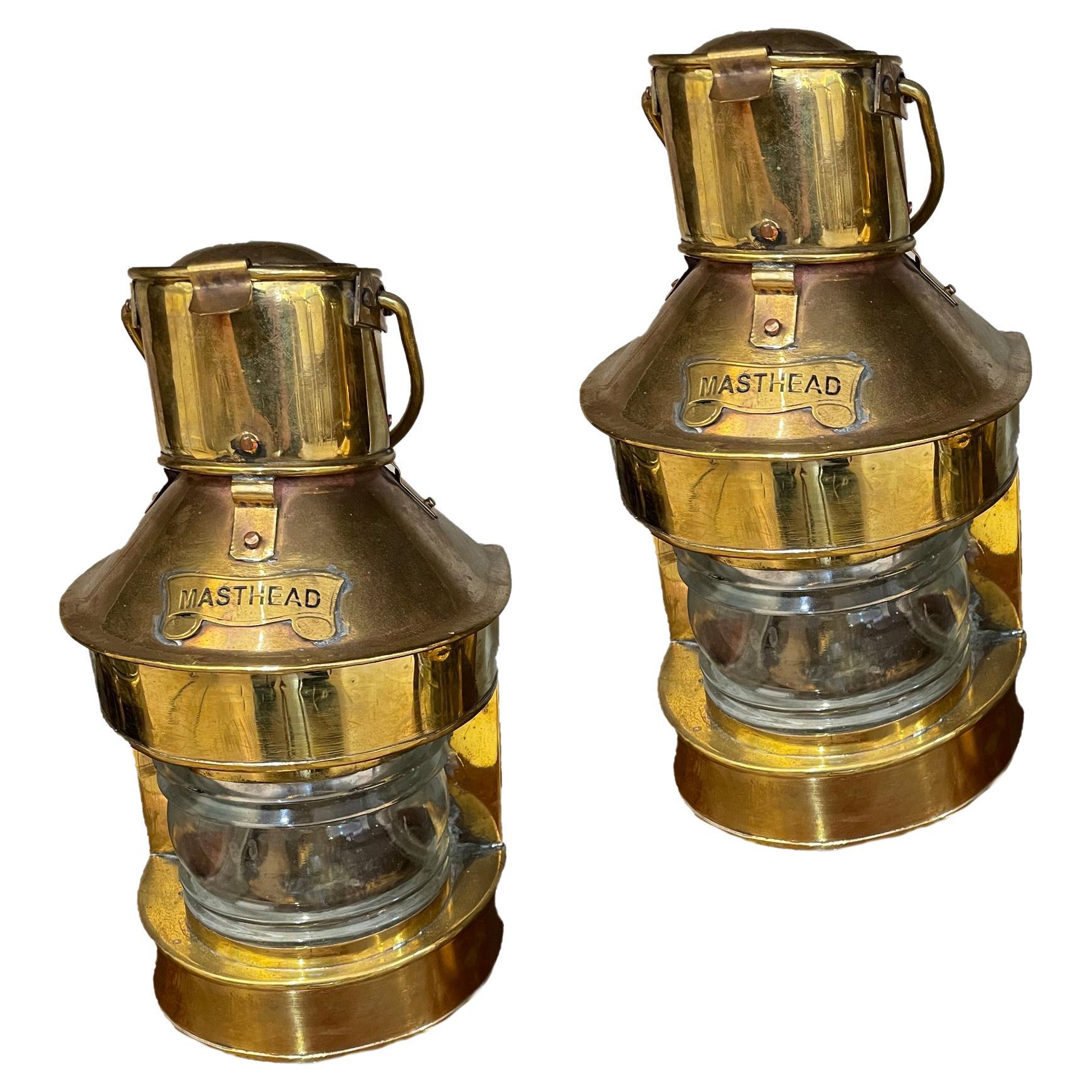 A pair of Masthead brass ship's navigational lights with Fresnel lens.  These are originally oil lights which slide out from the back.  They also have been converted to take an electrical bulb from above.  Both are an option.  We have also added a