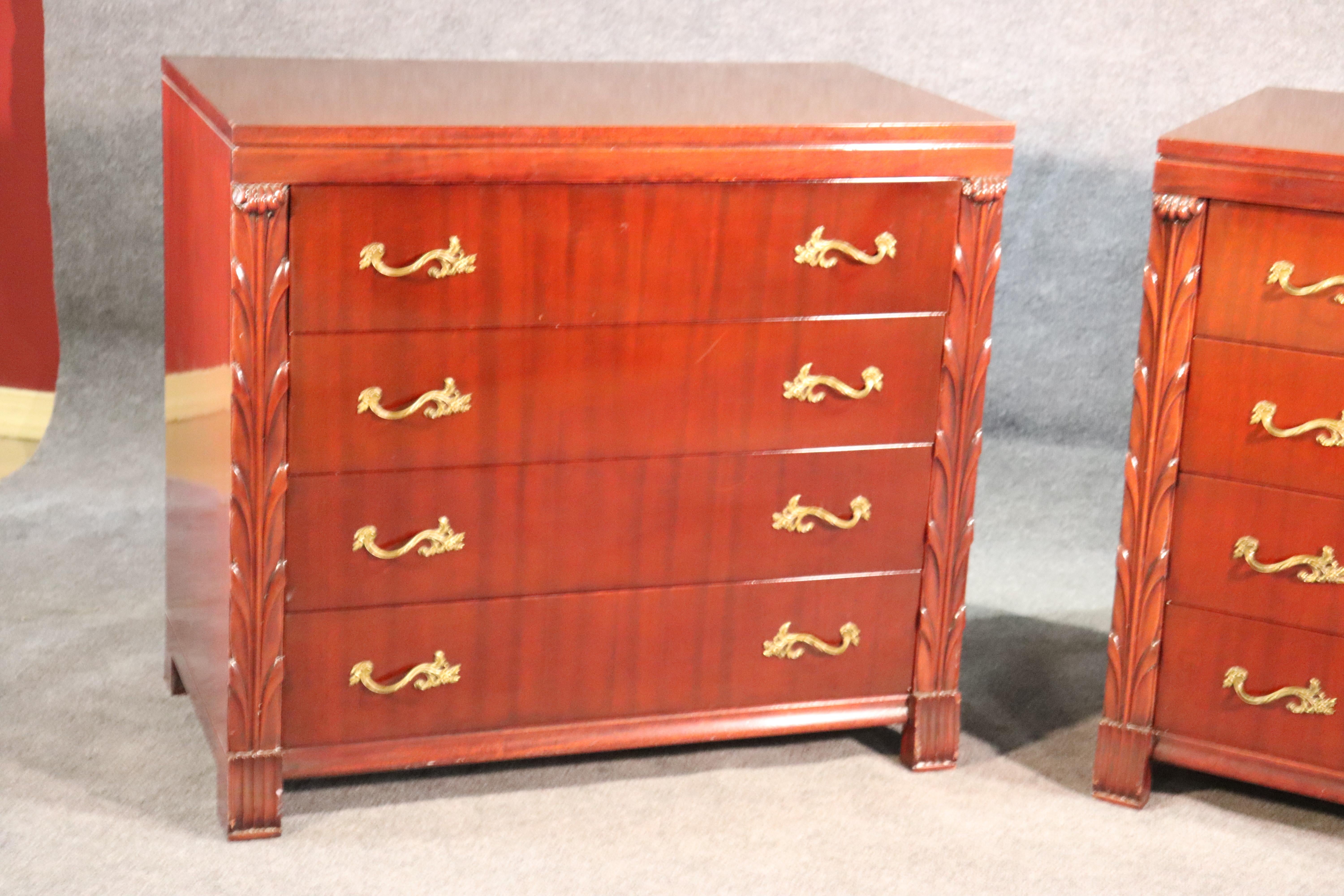 This is a nice paid of John Stuart Hollywood Regency dressers. They are in a red mahogany and not a traditional brown mahogany. They have dovetailed drawers and are in good condition. 
They measure 34.5 tall x 38 wide x 20.75 deep.