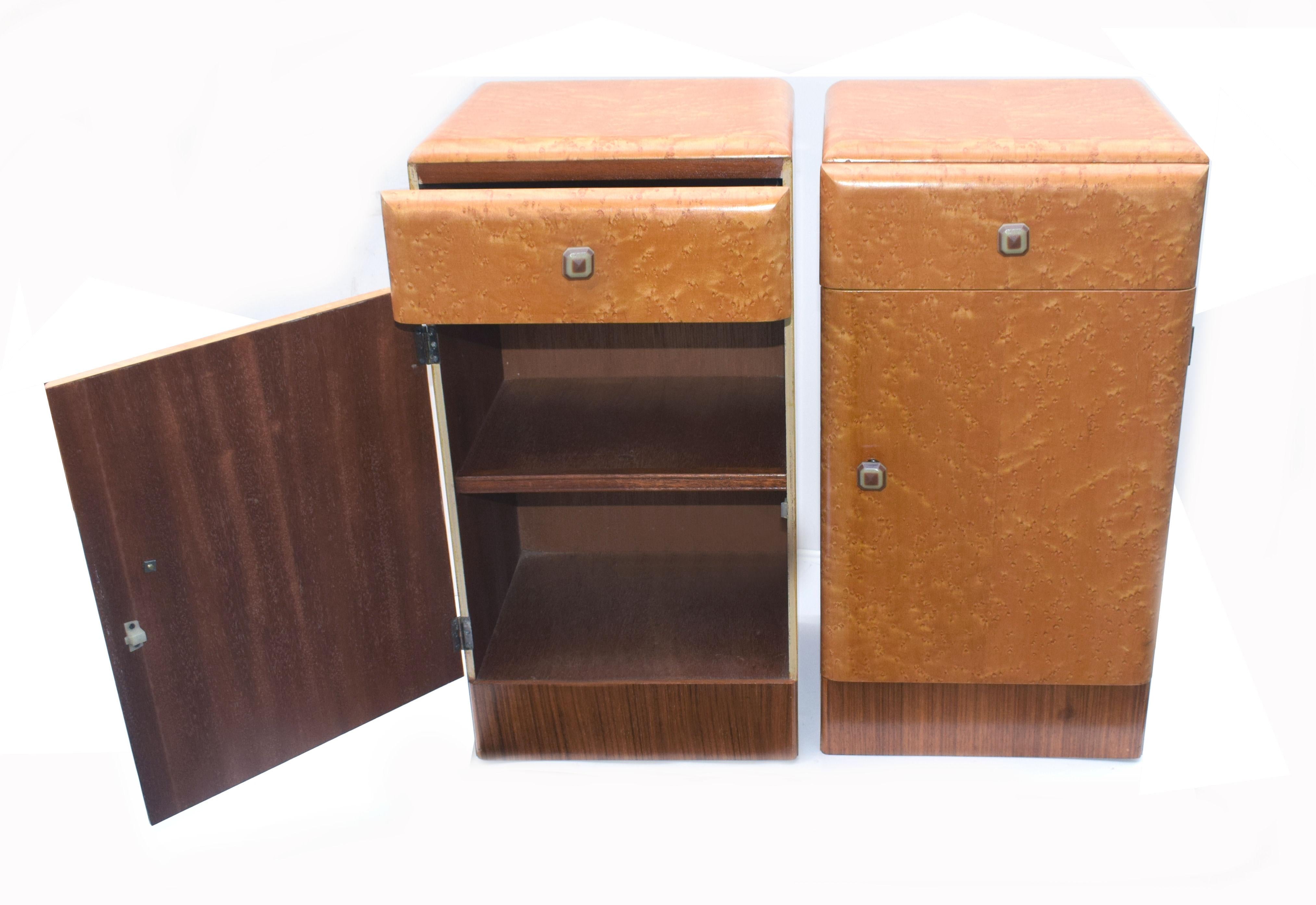 Fabulous pair of matching 1930s Art Deco bedside cabinet tables in a lovely blonde bird's-eye maple and walnut veneer. These cabinets originate from England and feature a pullout / pull-out drawer to the top which retains it's original Bakelite