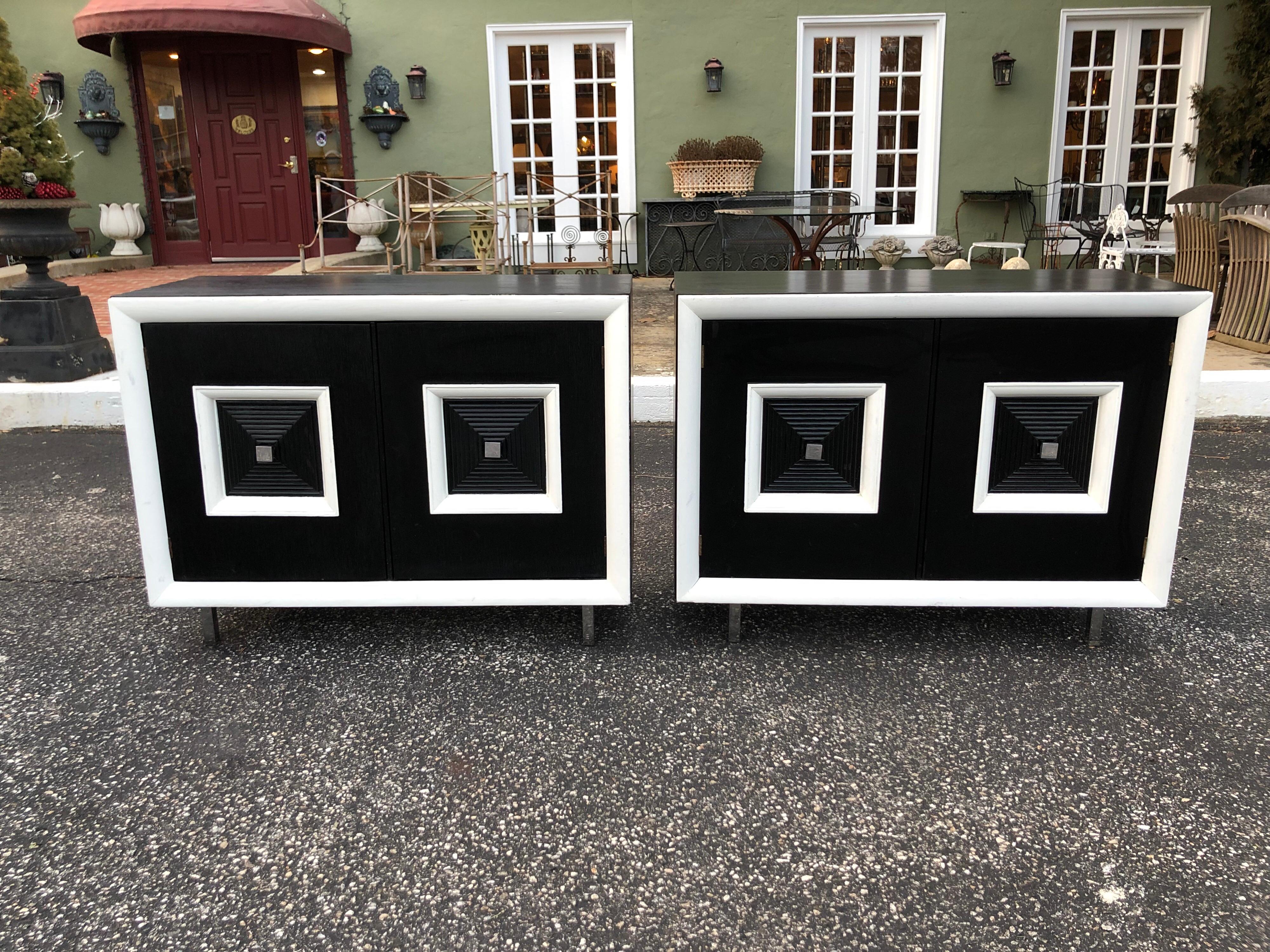 Pair of matching black and white Hollywood Regency cabinets. These stunning cabinets with paneled doors make a bold statement. Their dramatic black and white design pop with pizzazz. They would go with any deco or modern decor. They have excellent