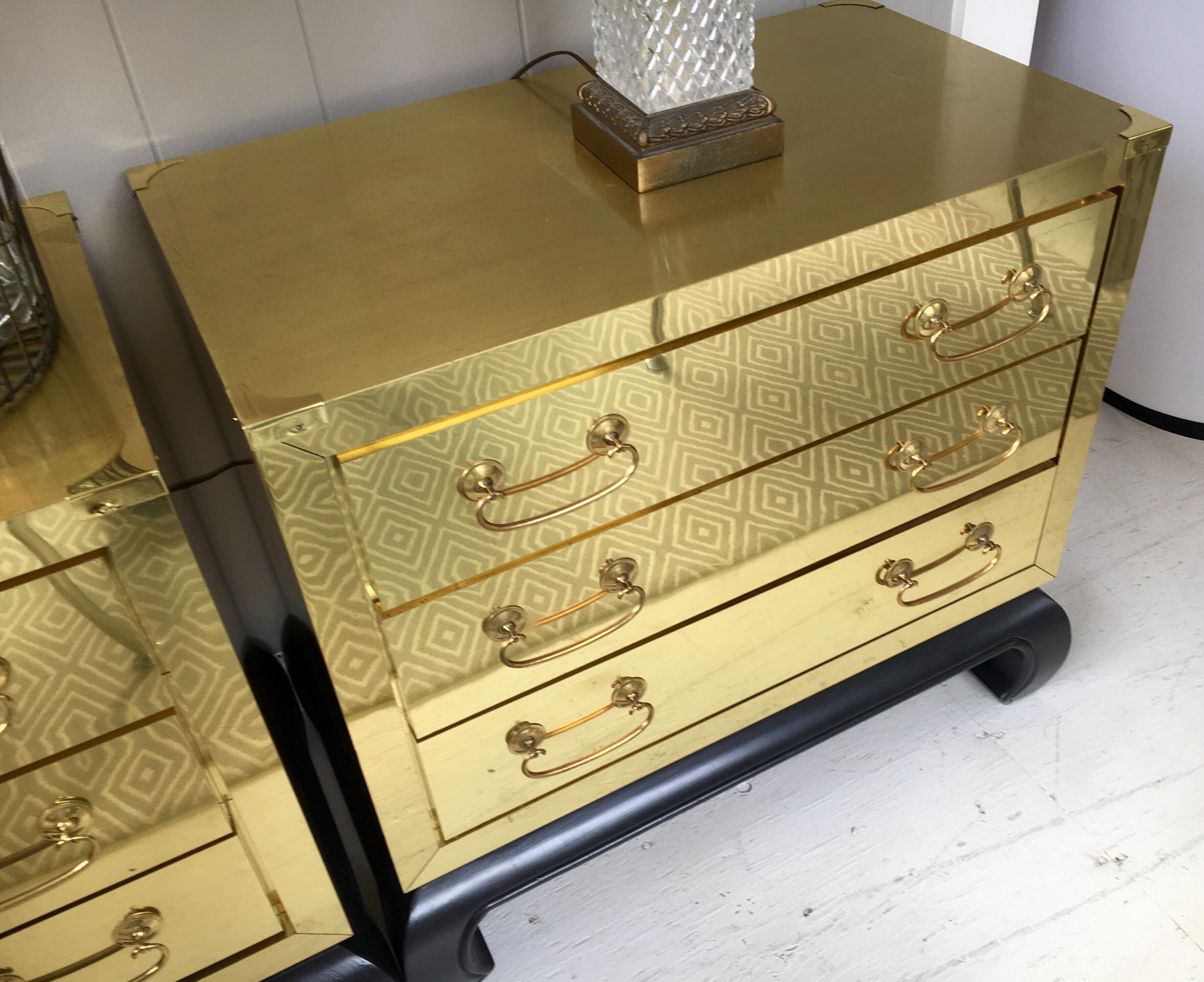 Pair of coveted brass campaign chest with black base and three drawers each. They are stunning.