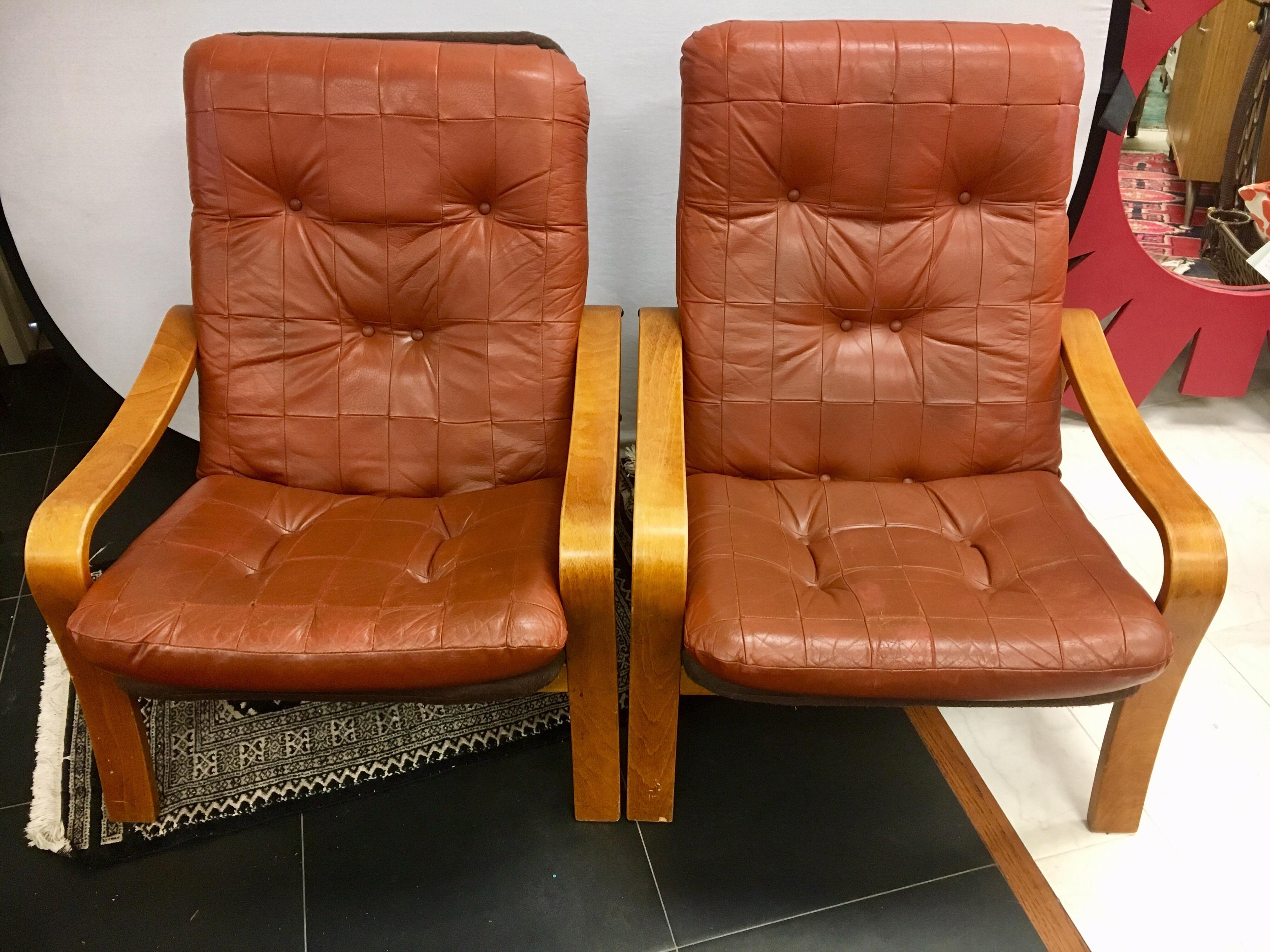 Danish modern teak lounge chairs with quilted and tufted leather back and seat cushion. Back and seat cushion is one piece, not attached.
