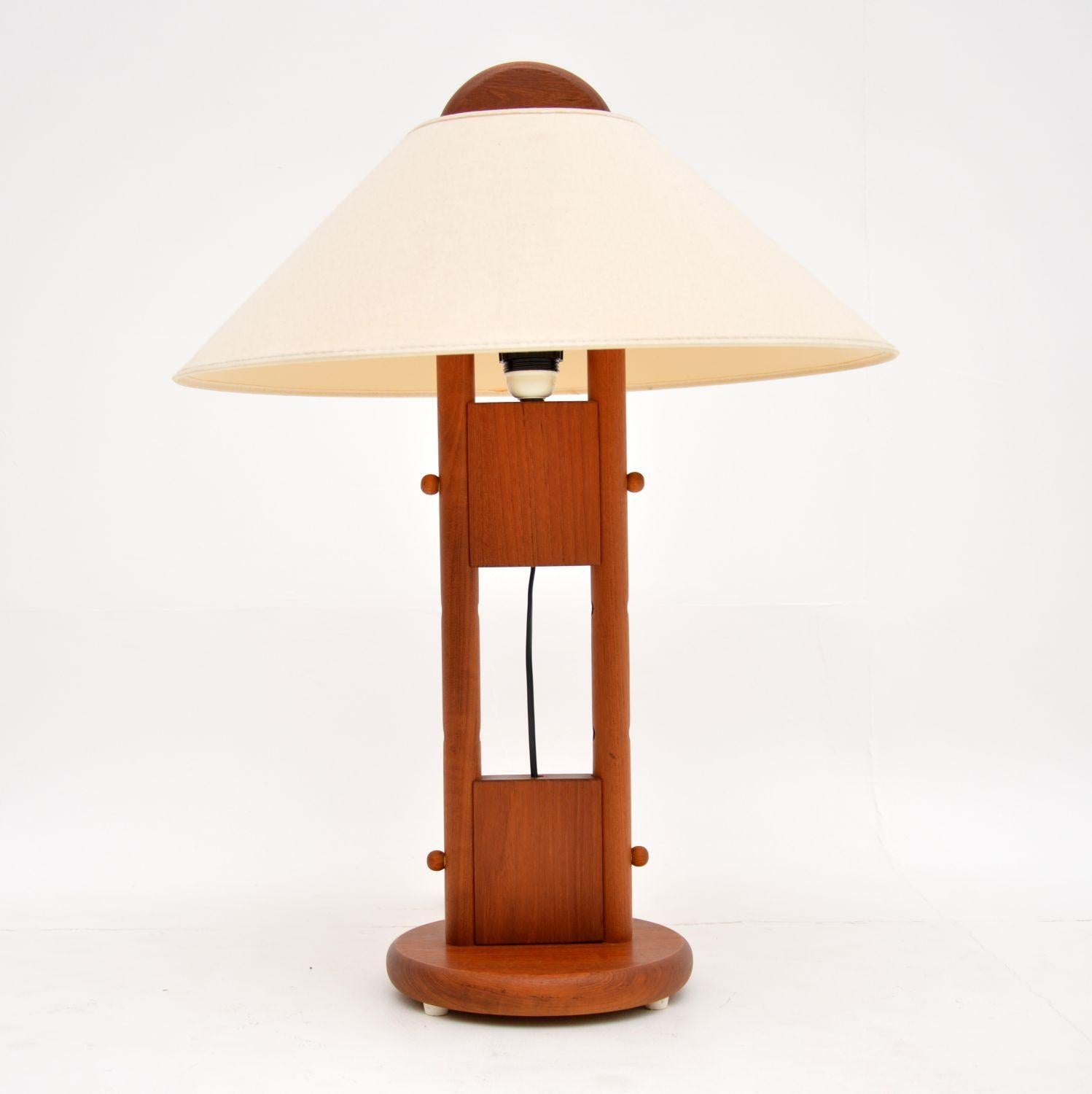A stylish and top quality matching pair of Danish vintage teak lamps. These date from circa 1970s-1980s, they were made by Lys. They are solid teak with beautiful original shades, the condition is excellent. The stands are clean, sturdy and sound,