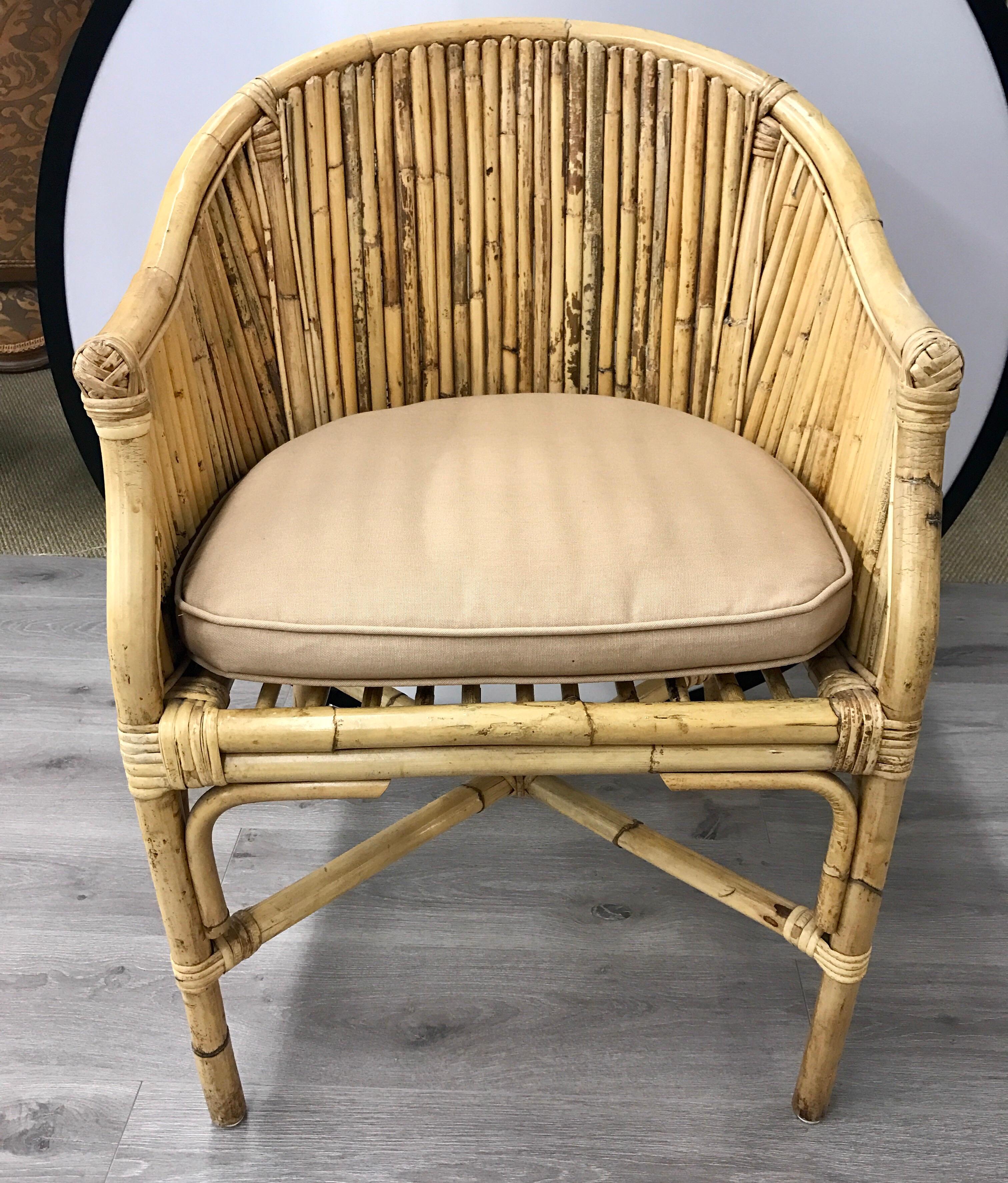 Pair of matching Mid-Century Modern style bamboo and rattan chairs with barrel back.