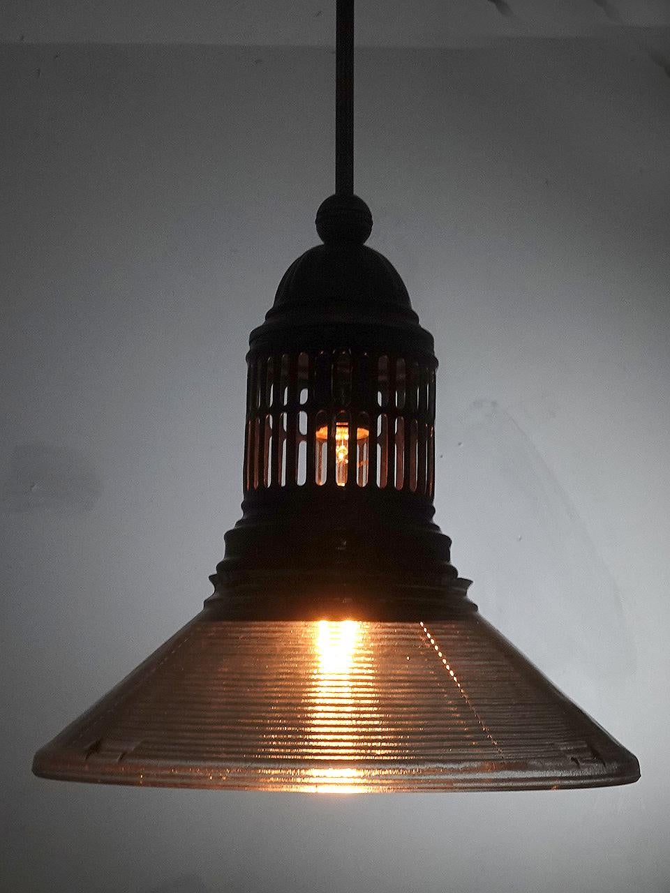 This is an interesting pair of converted gas lamps. The tented 12 inch diameter shade has a course prismatic pattern. The vented top has a dark blue baked on porcelain finish. Its interesting that the prismatic glass as well as the vented shade