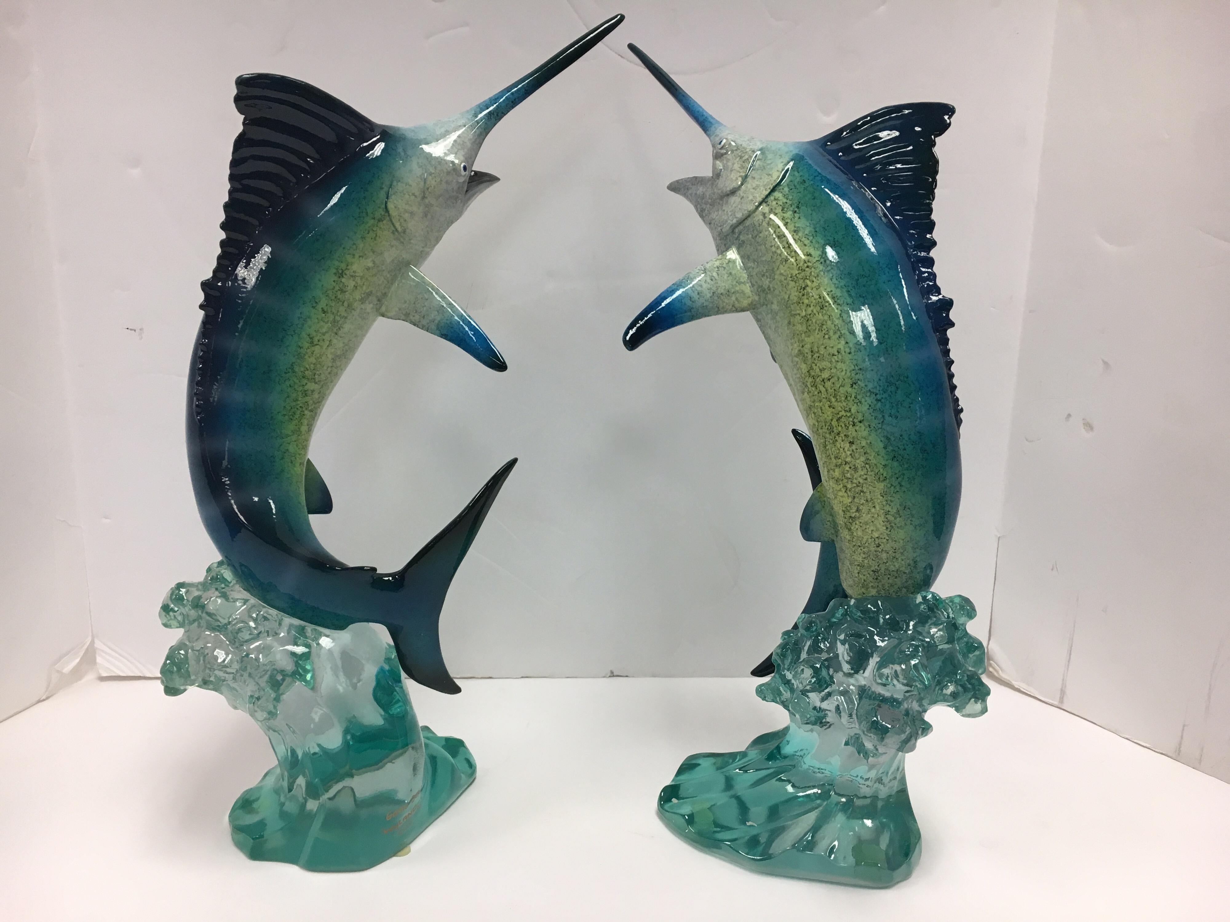 Elegant pair of Lucite sculptures from Robert Wyland with signature/hallmarks at base.