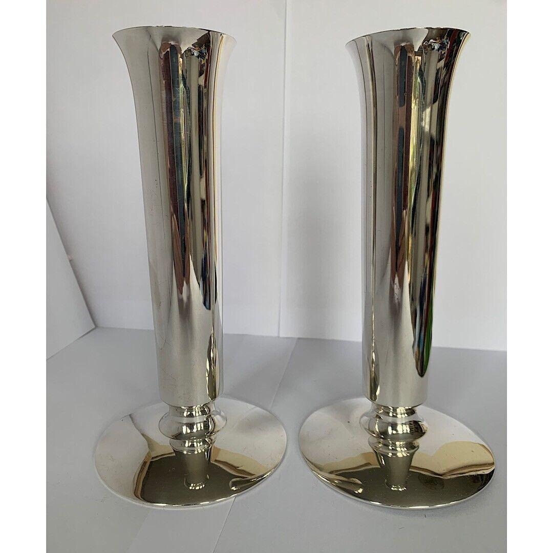These vases are in excellent vintage condition. The have large round bases and a sleek, classic design. They would look beautiful on any table. A pair of George V silver trumpet vases, by Edward Barnard & Sons, London 1934, each with
