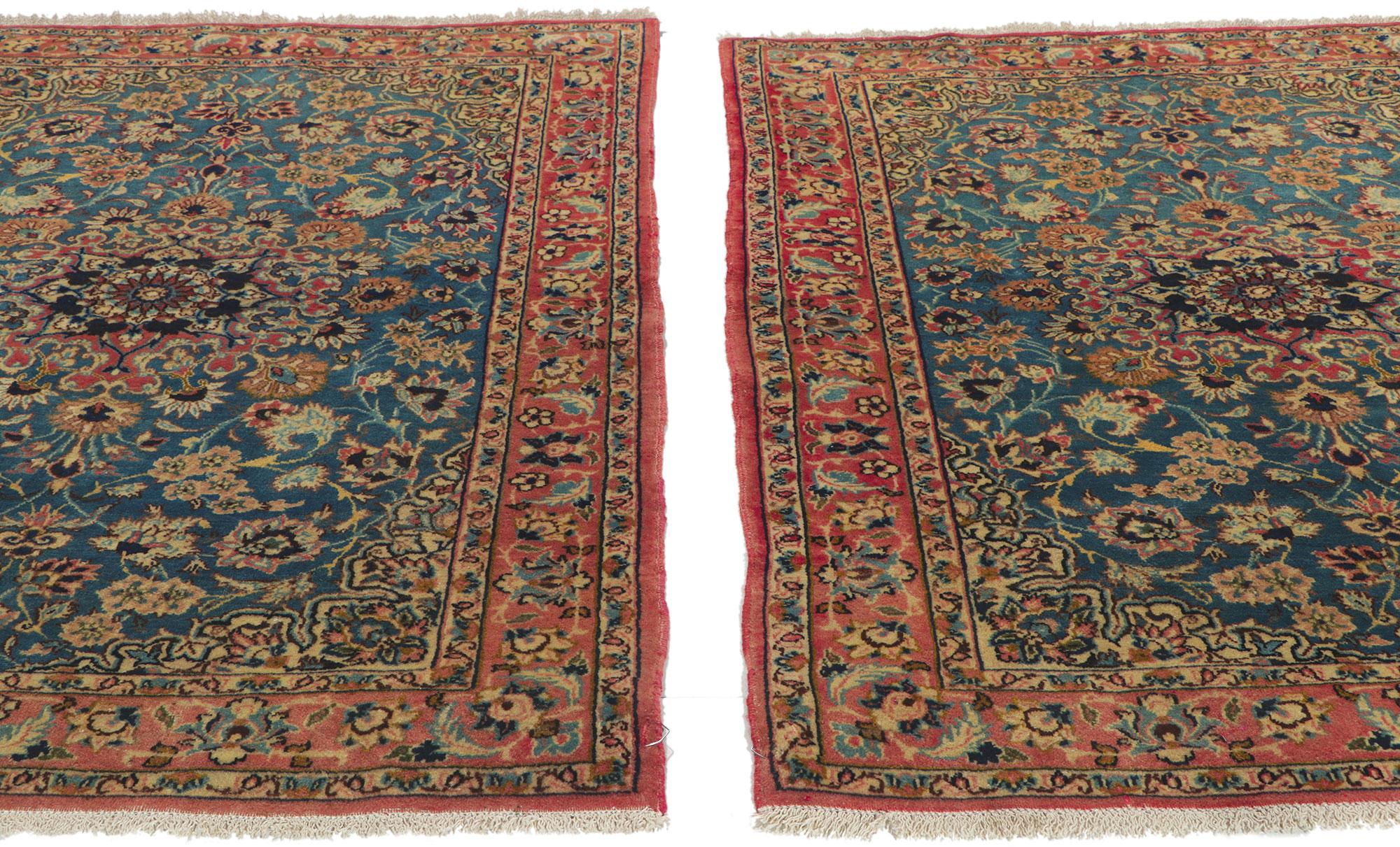 Pair of matching vintage Persian Isfahan rugs
With its timeless style, incredible detail and texture, this pair of hand knotted wool vintage Persian Isfahan rugs are a captivating vision of woven beauty. The eye-catching botanical pattern and
