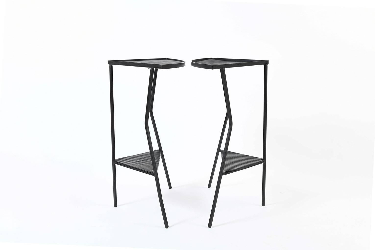 A pair of black enameled ion and rigitule two tiered side tables, in the manner of Mathieu Mategot (1910-2001)
France, circa 1955.