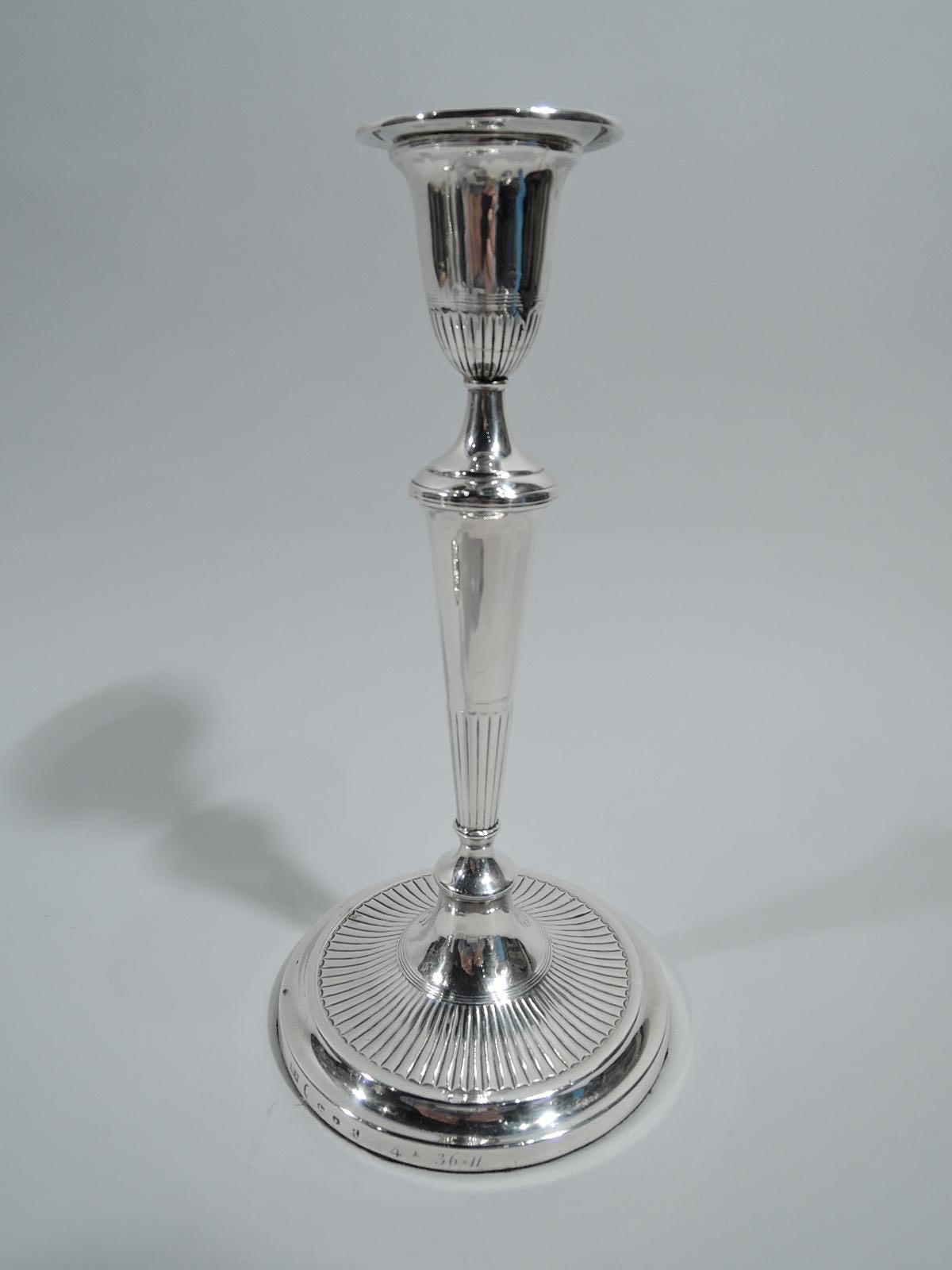 Pair of George III sterling silver candlesticks. Made by Matthew Boulton in Birmingham in 1789. Tapering on raised foot. Urn socket with detachable bobeche. Fluting and reeding. Stylish Neoclassicism by an inventive silversmith. Fully marked.