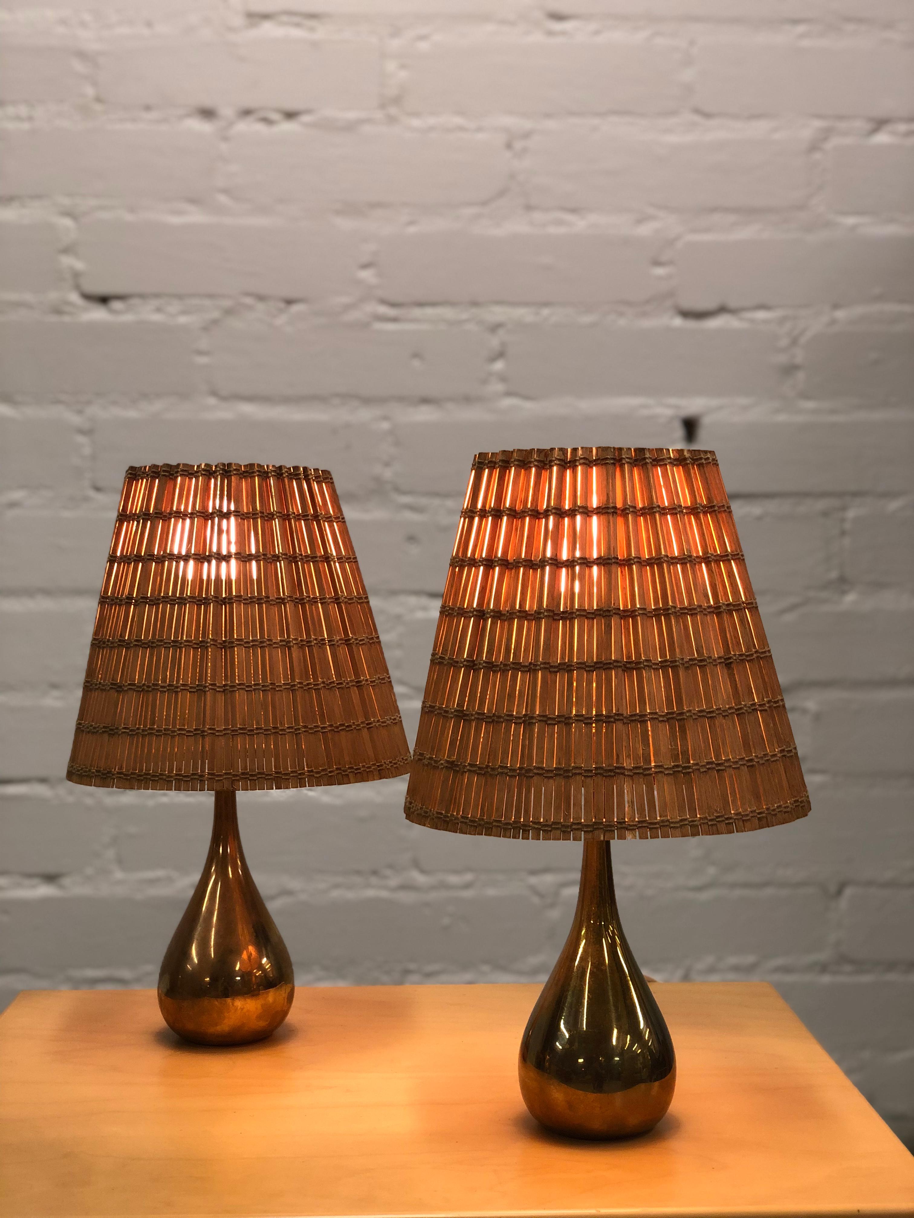 A pair of table lamps in full brass with a new rattan shade. Designed by Mauri Almari and manufactured by Idman. This model k11-21, is often referred to as the 