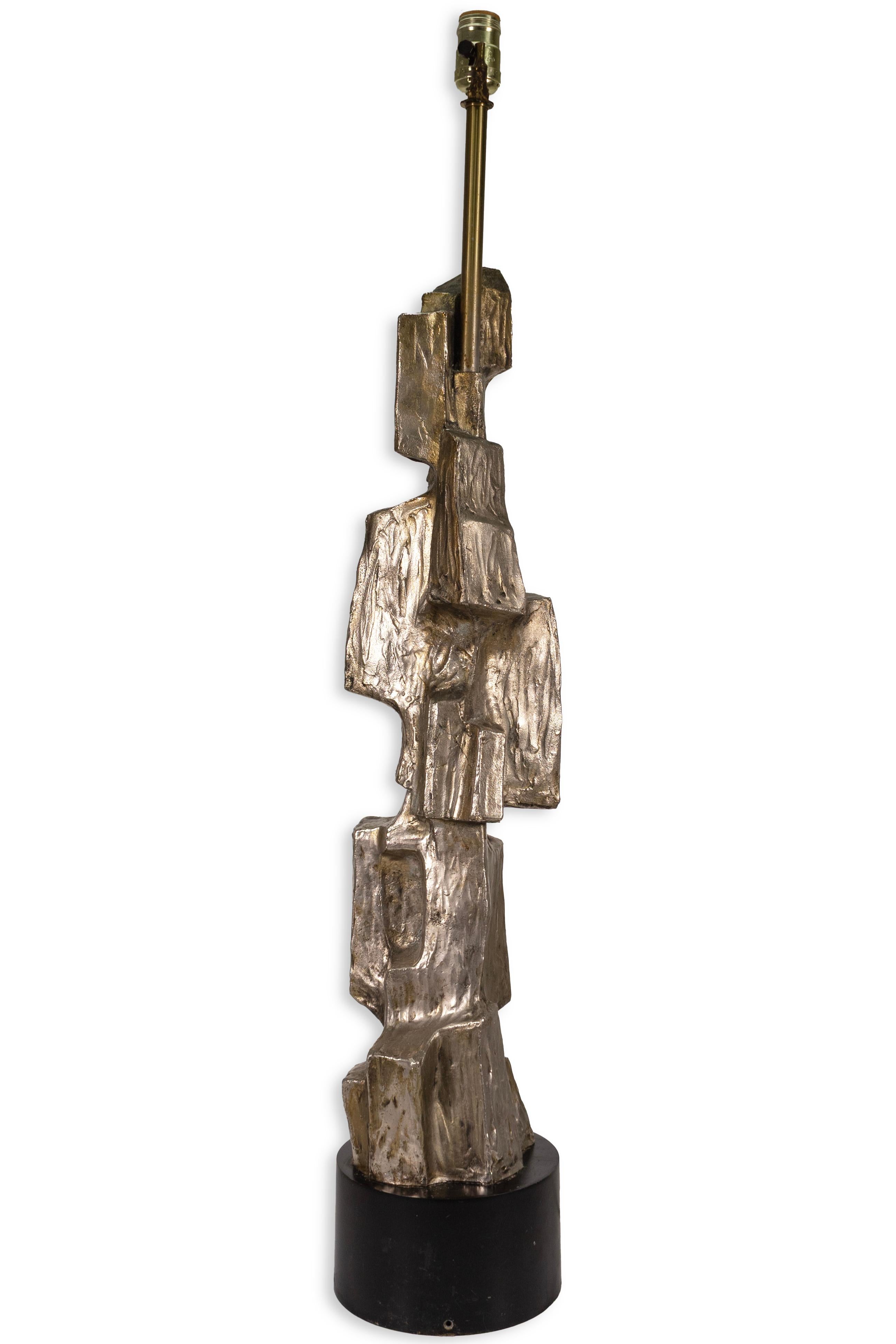 Pair of Maurizio Tempestini Brutalist Bronze Table Lamps. These tall lamps serve as an eye-catching addition to any space. Their unique geometric shape and impressive size are sure to spark conversation. The lamps feature a brushed bronze color that