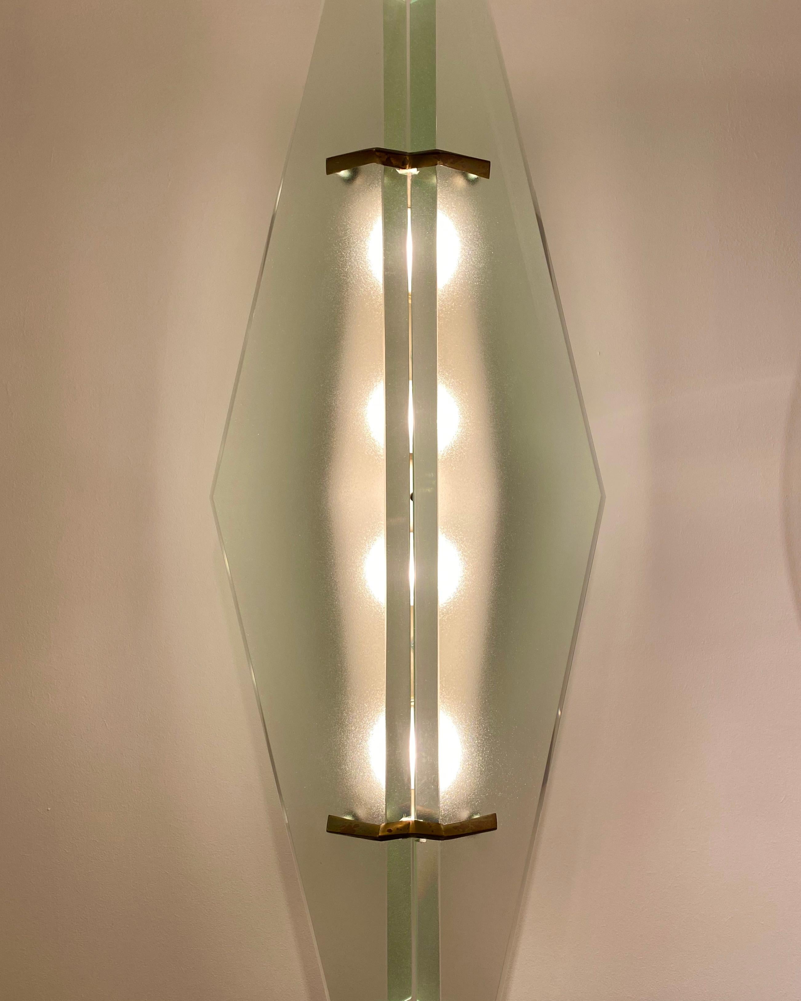 An original pair of '1937' model wall sconces designed by Max Ingrand for the prestigious Milanese company, Fontana Arte. Designed and produced in 1958, these beautiful wall lights each comprise of a black-painted metal frame with two large
