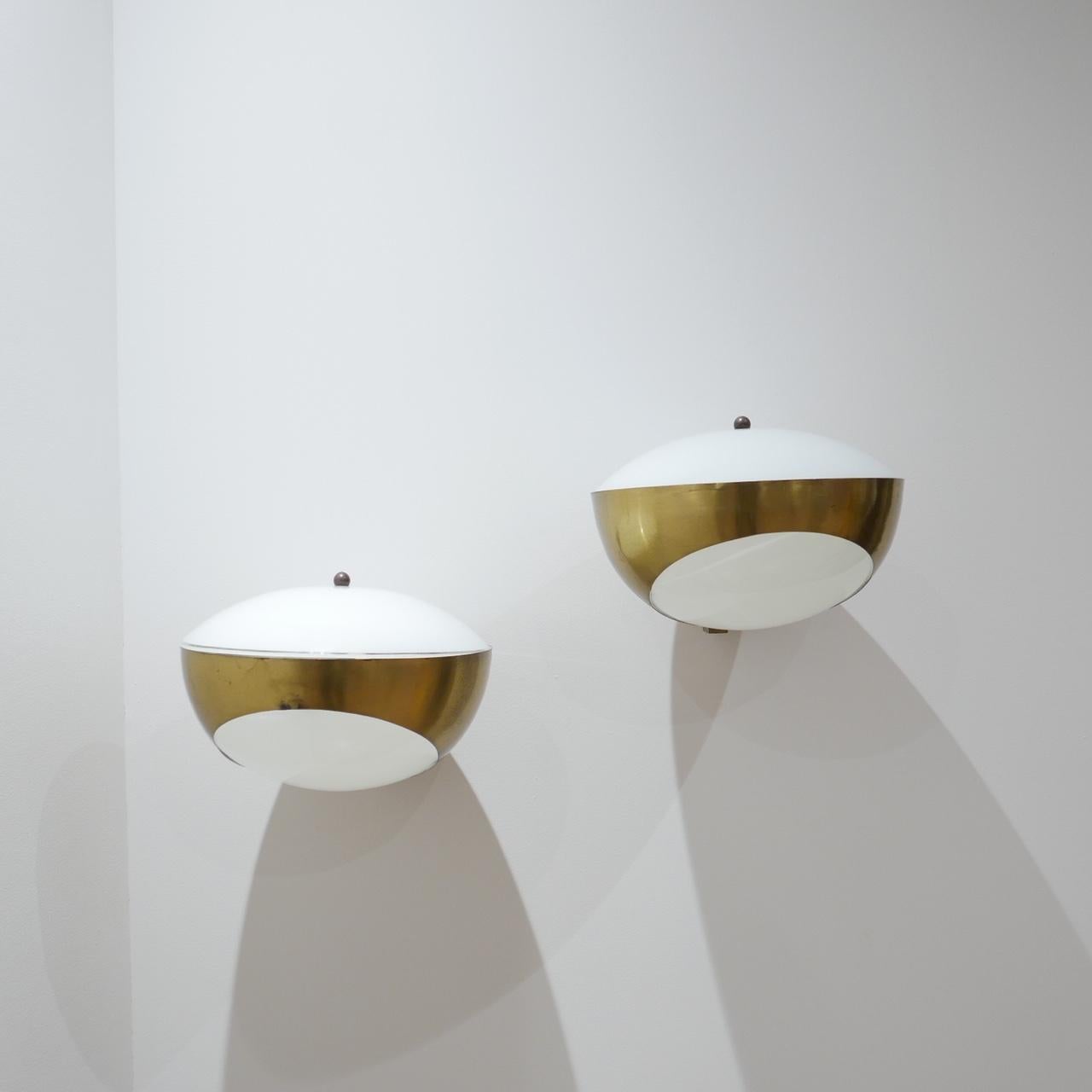 A rare pair of Max Ingrand wall lights made for Fontana Arte.

'1963' Model. 

Italian. 

Brass metal and opaline glass. 

Price is for the pair. 

Patina consistent with age, light wear but generally very good condition. 

Dimensions: