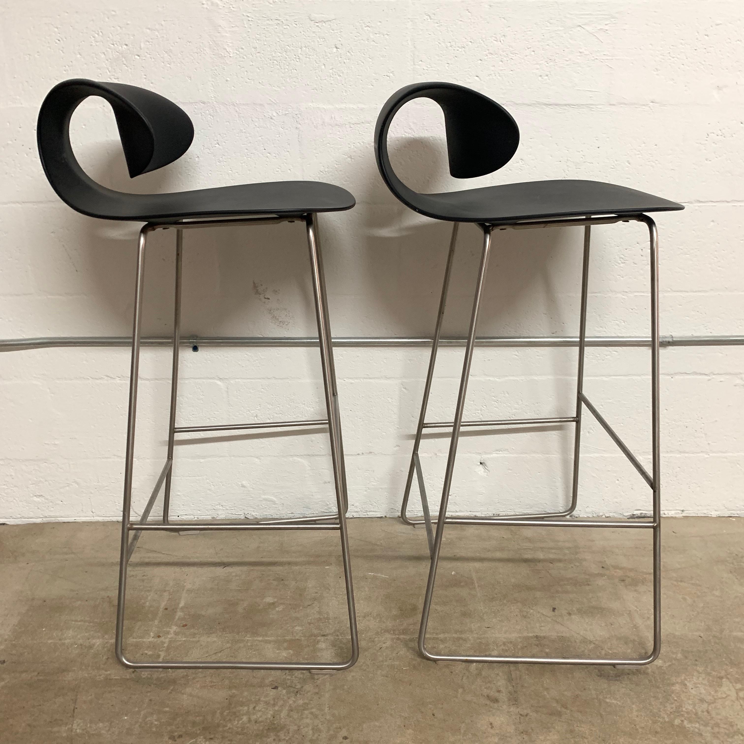 Sculptural pair of barstools rendered in molded polycarbonate with a steel frame and footrest designed and manufactured by Sawaya & Moroni.