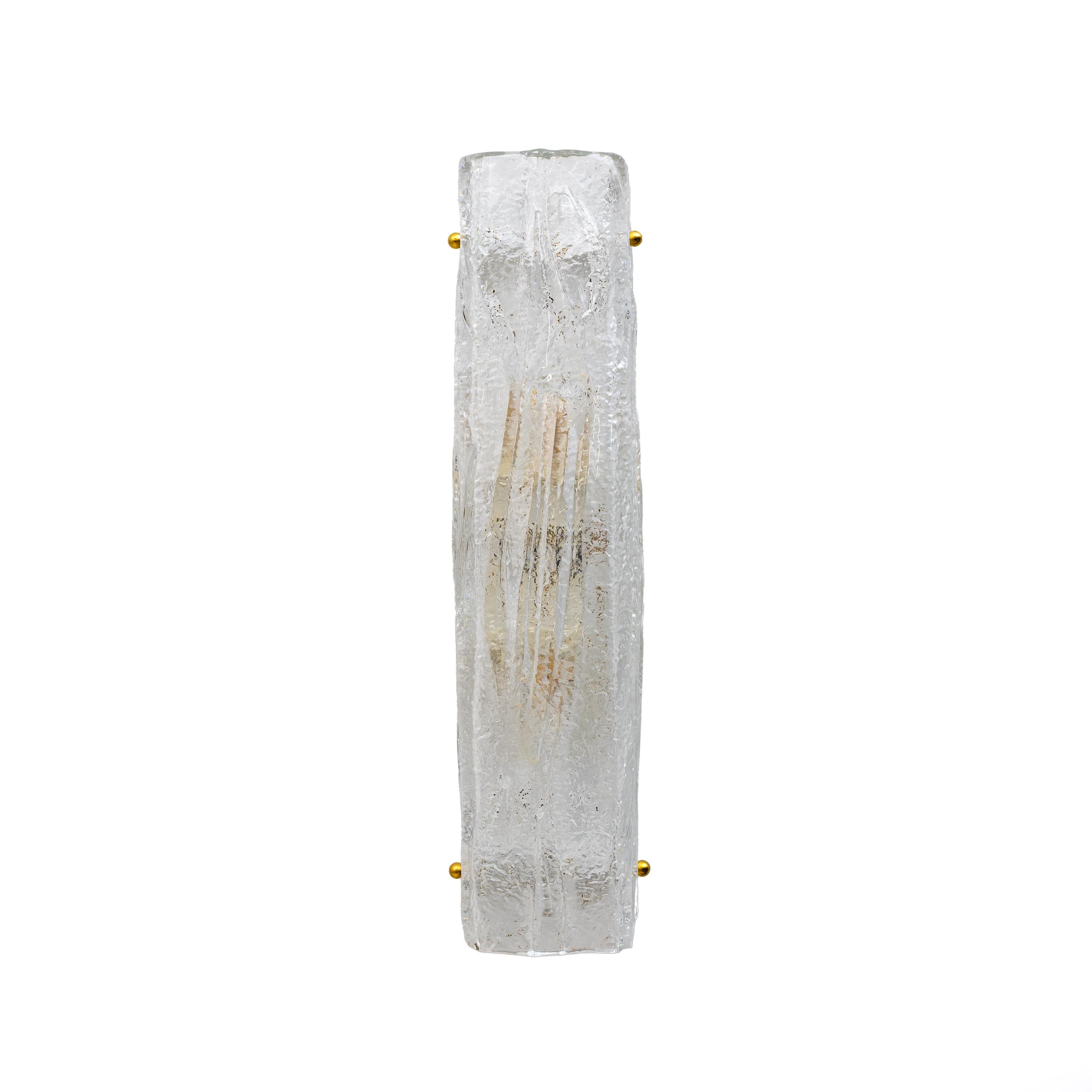 Pair of curved Murano glass wall lamps in crystal-colored Mazzega style. The glass reproduces tree bark. The shape of this lamp makes it perfect for columns and hallways. Equipped with two E27 or E26 candle holders, rewired to European and American