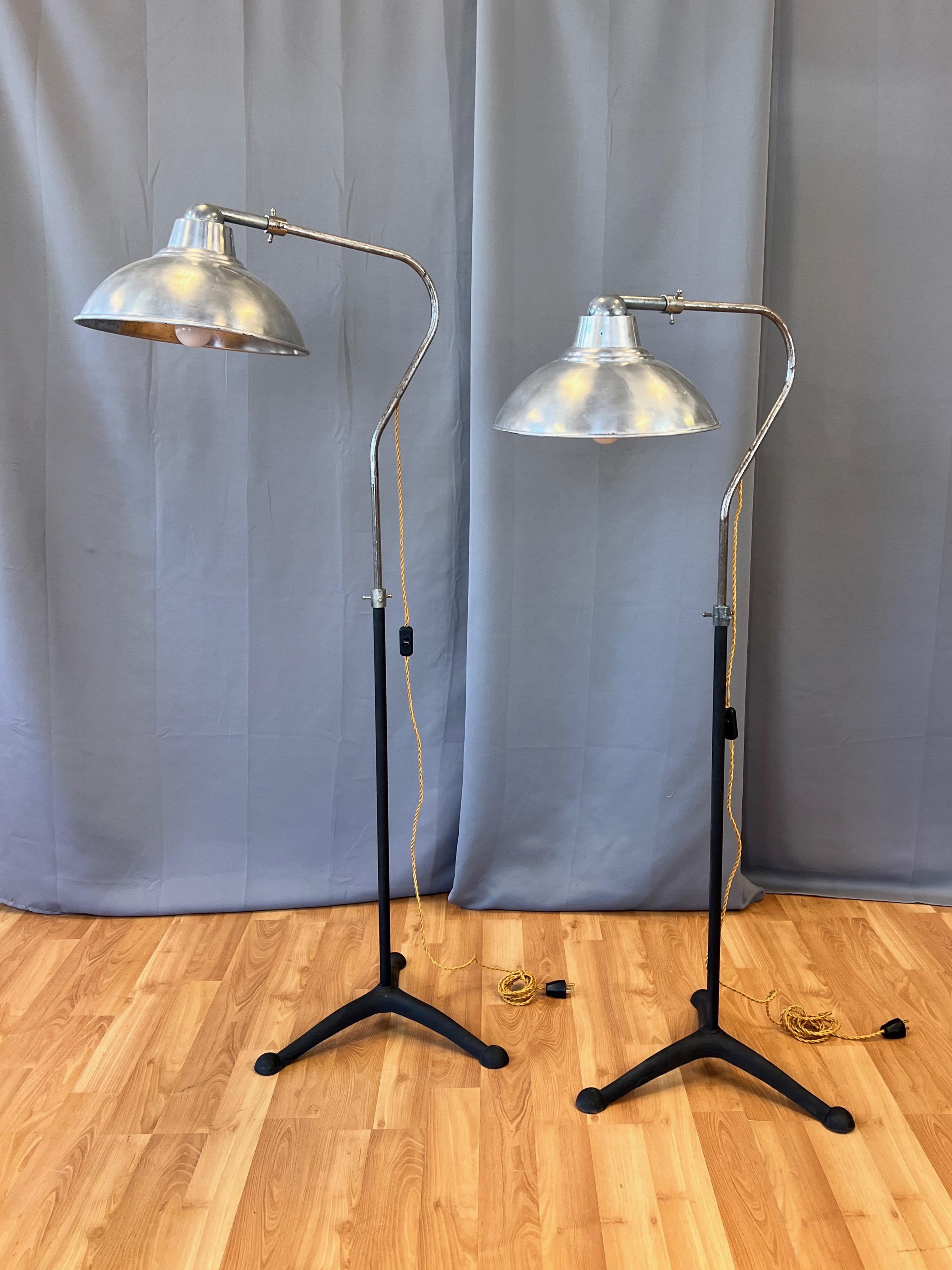 A rare pair of uncommon 1930s McCall’s Desert-Air industrial adjustable-height aluminum and cast iron floor lamps.

Fifteen-inch-diameter polished aluminum reflector shade with rotatable cast aluminum mount on bare metal gooseneck-shaped