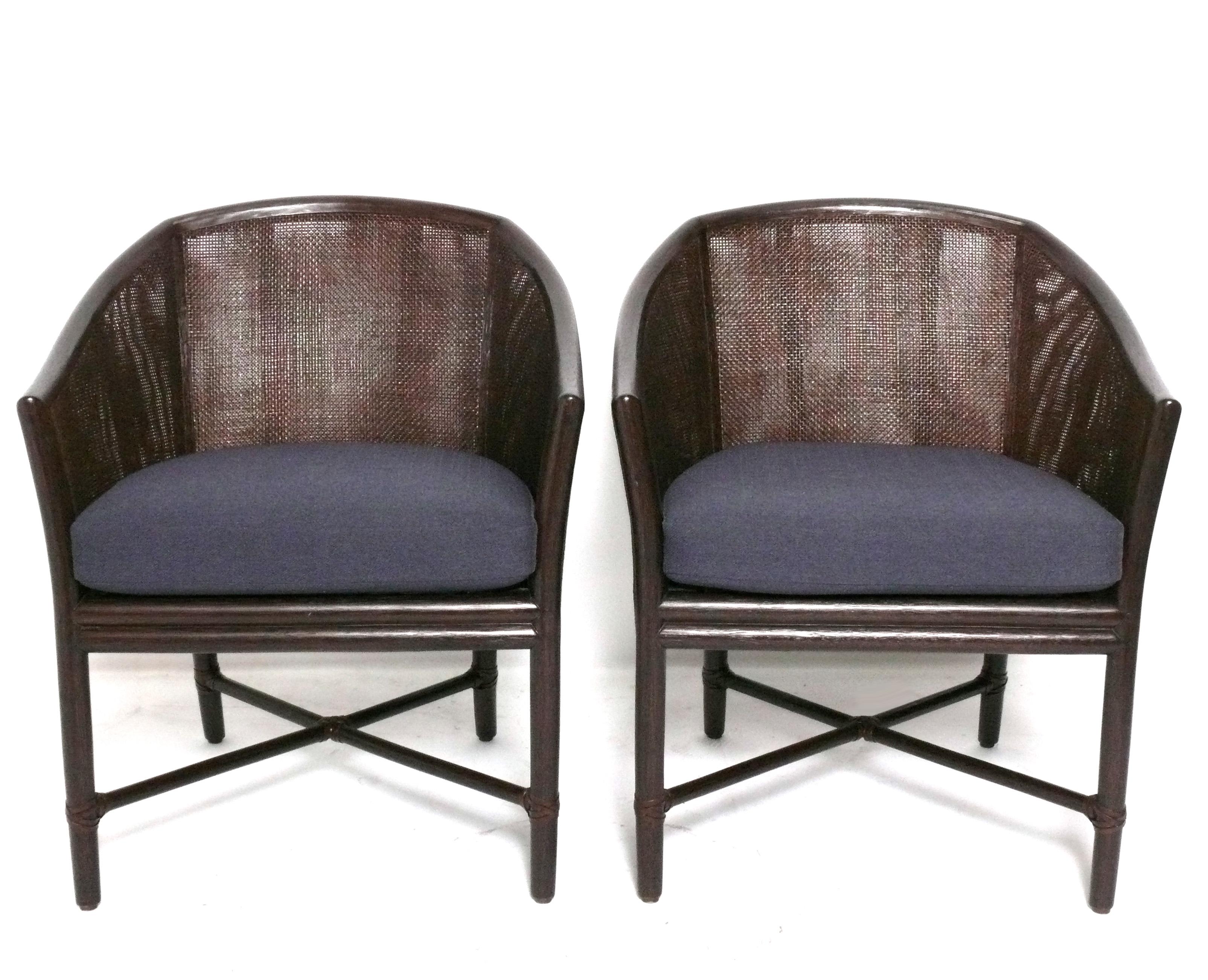 Pair of Chinoiserie Style Bamboo and Cane Armchairs or Lounge Chairs, made by McGuire, signed, American, circa 2000s. They retain their original espresso brown finish and navy blue cushions.