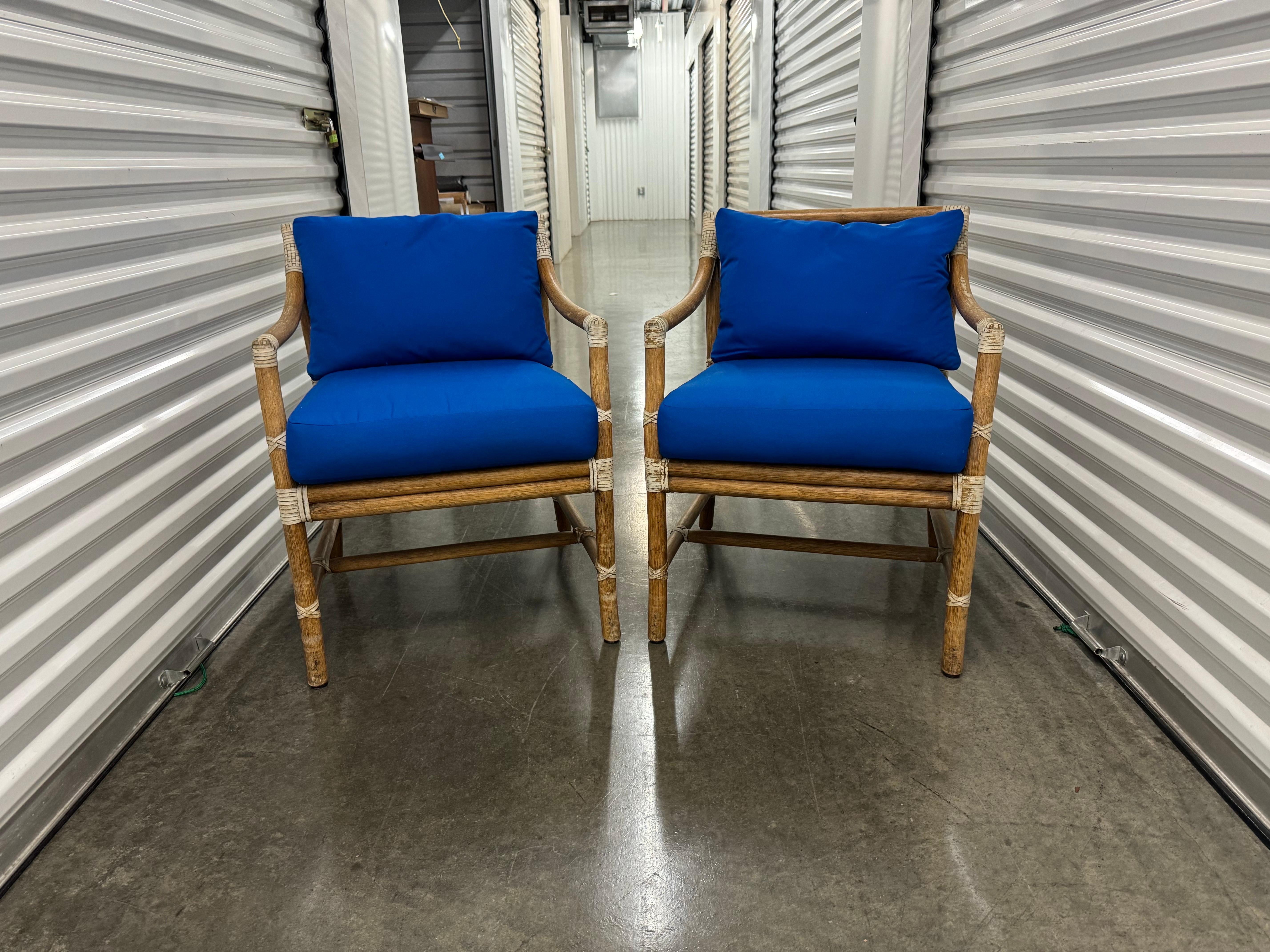 Gorgeous set of 2 California organic modern McGuire lounge chairs. or arm chairs. Made with thick bamboo and rattan and weaved around the joints with rawhide leather. These chairs are finished with McGuire's signature Target design splat. Both