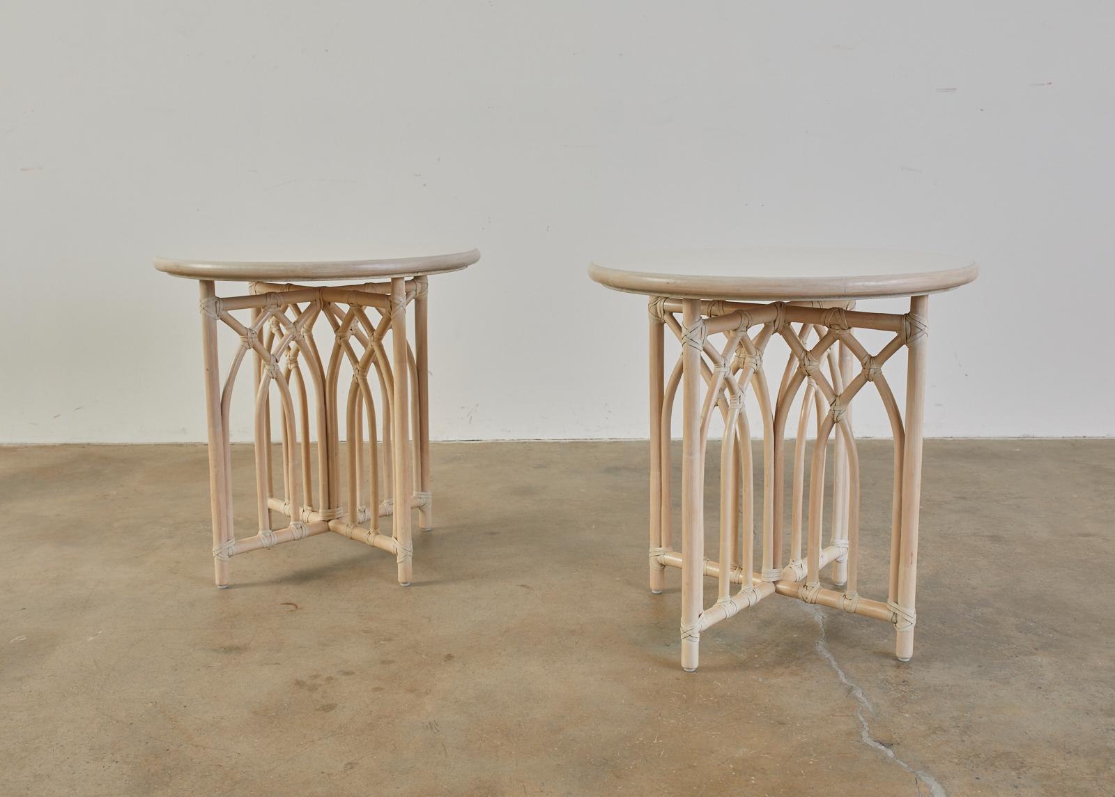 Fantastic matching pair of genuine McGuire drink's tables or side tables featuring a lacquered cerused finish. handcrafted from rattan decorated with arch-shaped motifs with leather rawhide laces on the exposed joints. The bases are topped with