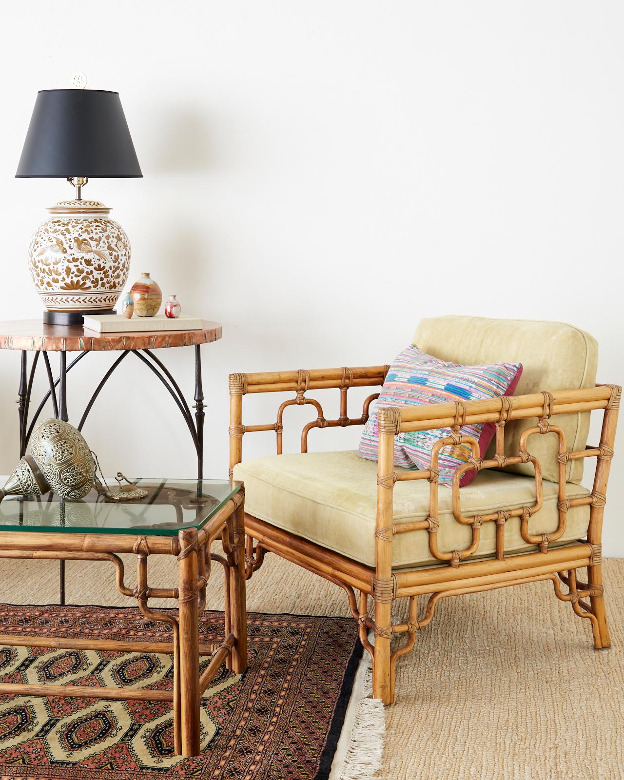 Asian inspired pair of bamboo rattan cube form lounge or club chairs made by McGuire. Created in the California organic modern taste featuring a decorative open fretwork design on the frame known as Marview chairs designed by Elinor McGuire. The