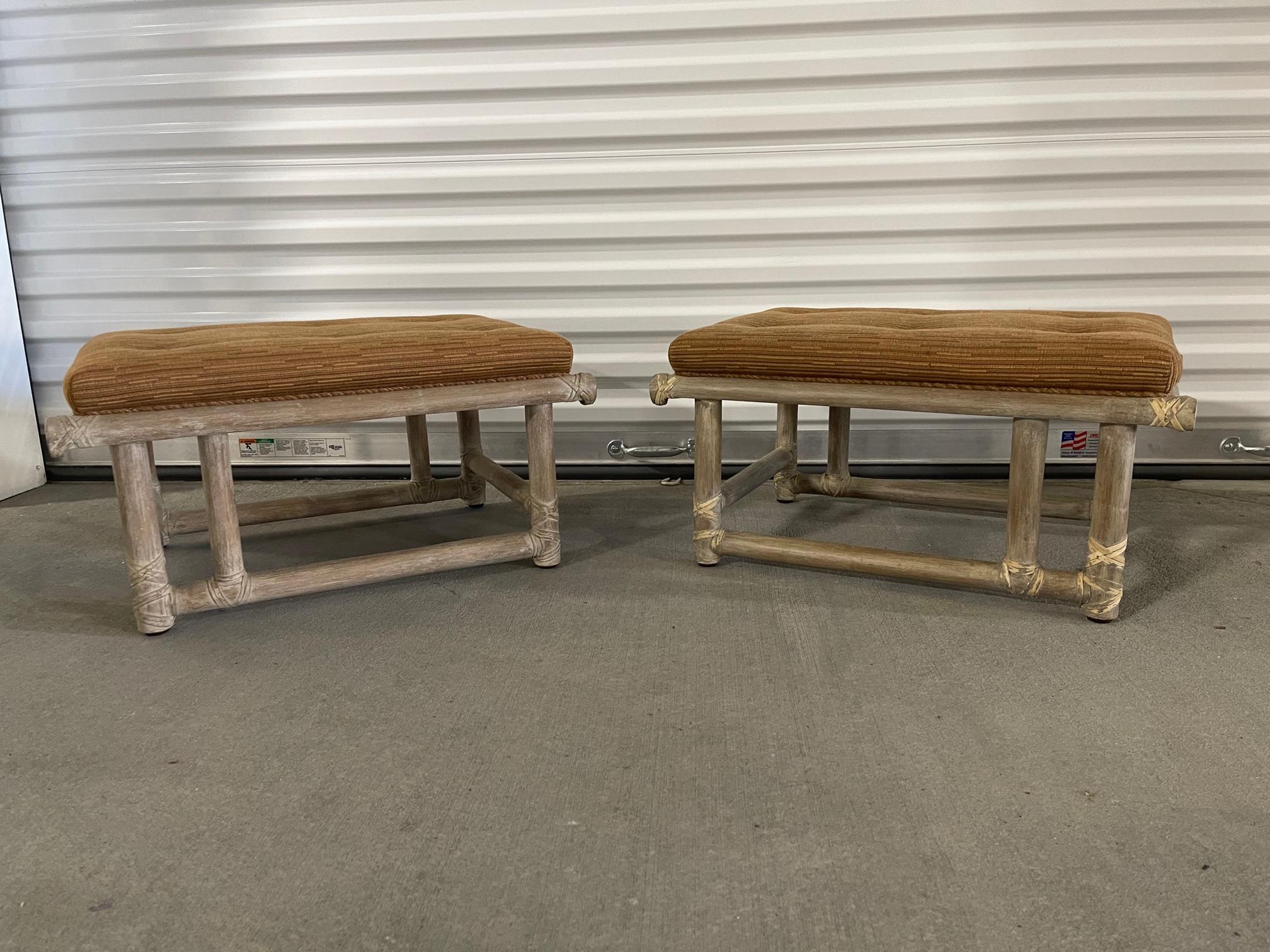 Pair of mid-century lacquered bamboo ottomans or foot stools featuring a Cerused or whitewashed finish with woven leather straps and stretchers. Signed McGuire on a brass label.
   