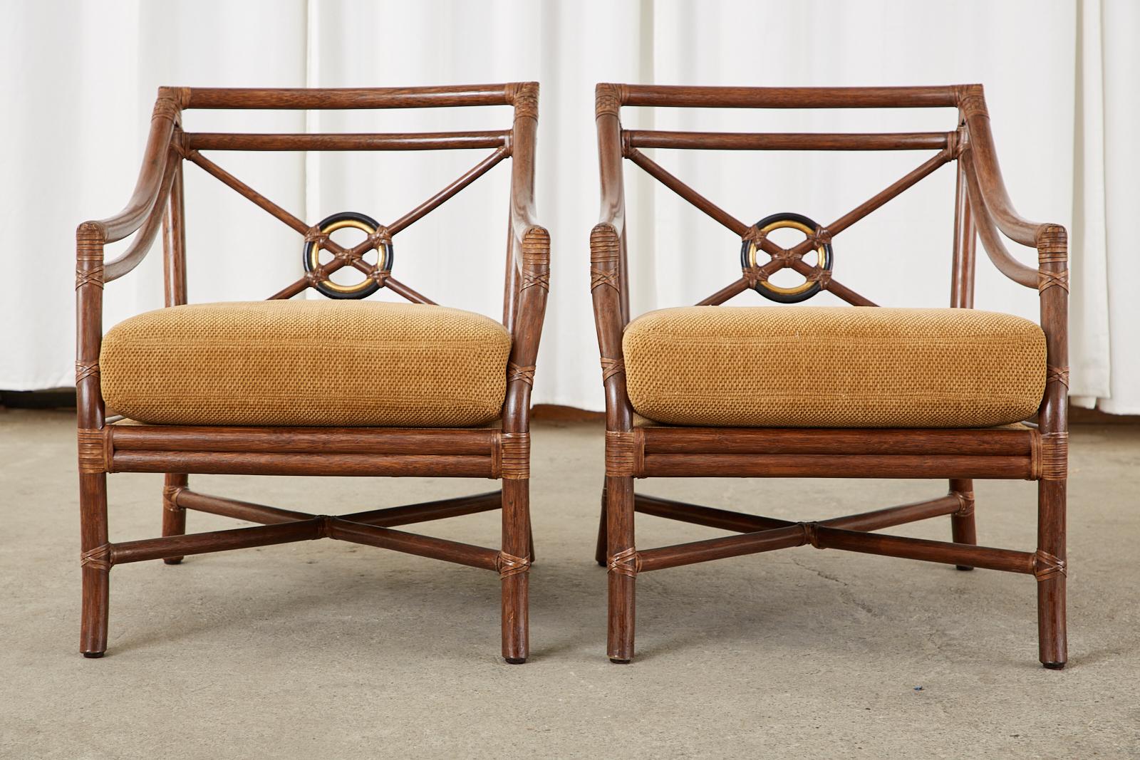 Stylish pair of McGuire lounge armchairs featuring their iconic target design back splat. Bespoke pair of chairs designed by Elinor McGuire in the California organic modern style from rattan poles lashed together with leather rawhide laces. The