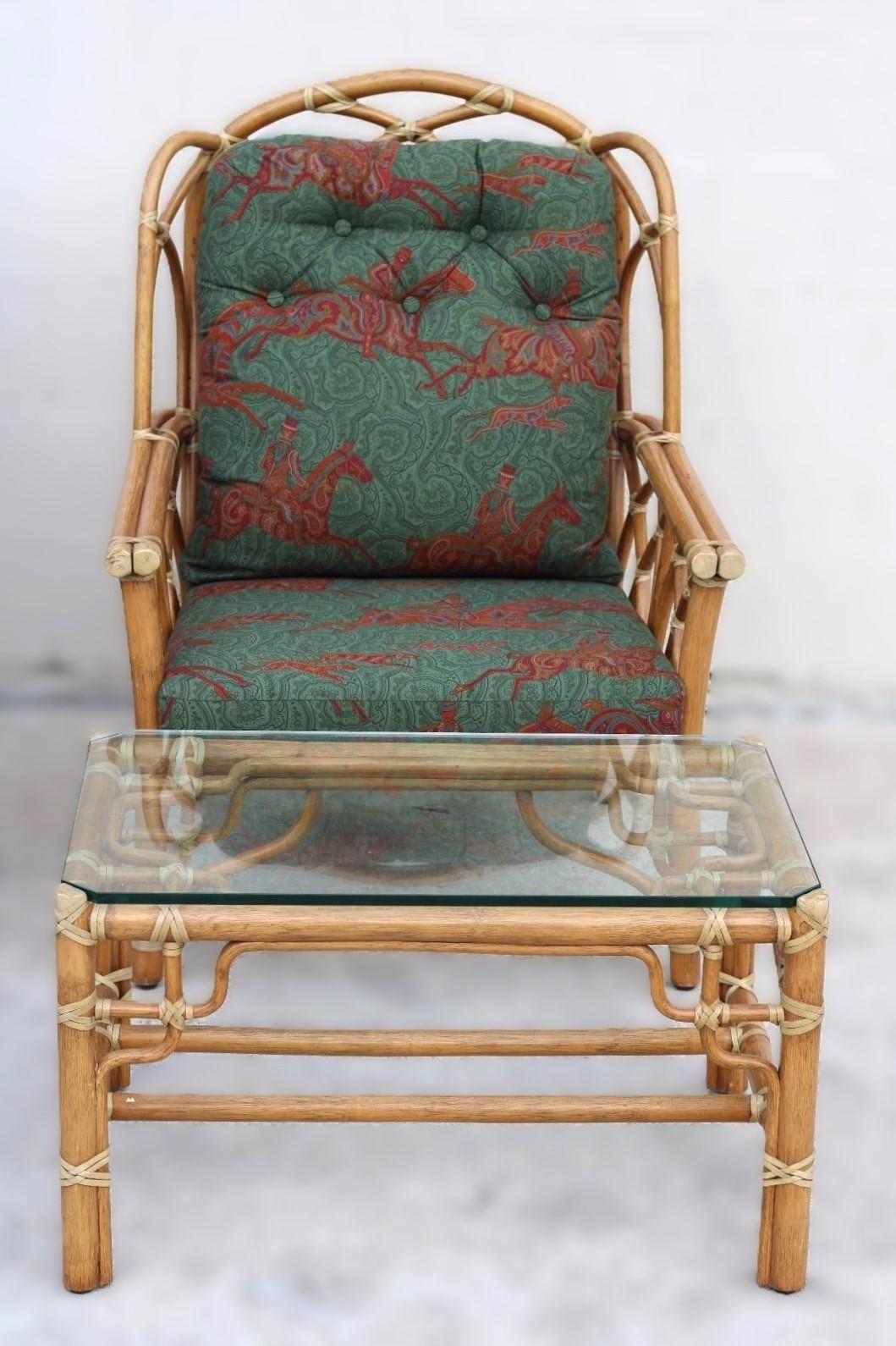 Pair of genuine McGuire rattan wing back chairs with an ottoman and a side table with inset glass, designed by breakthrough innovator Elinor McGuire. The design is famous for its rattan cathedral arches design and McGuire's signature rawhide lacing.