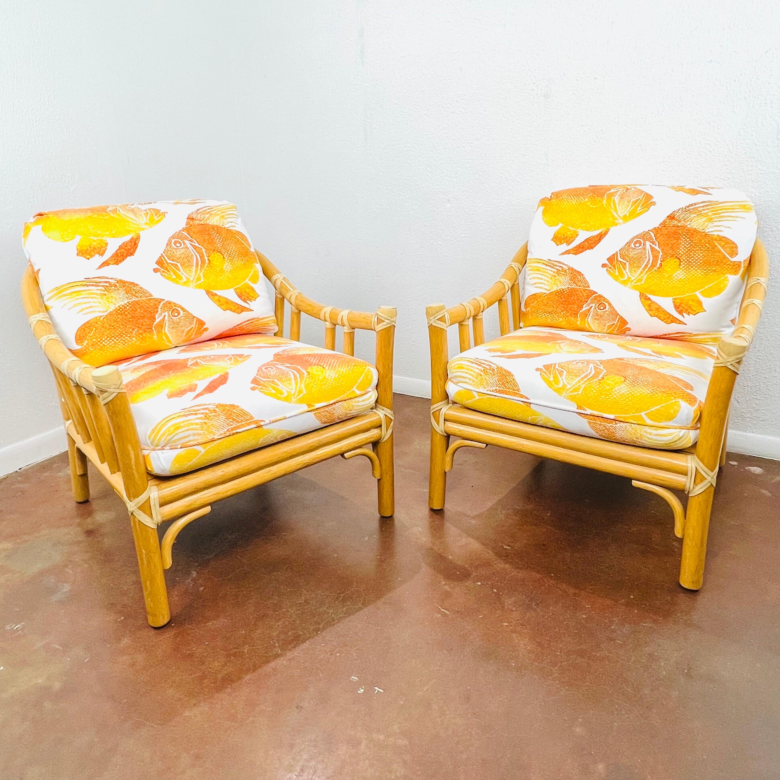 Gorgeous pair of McGuire rattan armchairs with goldfish print upholstery. Excellent condition.