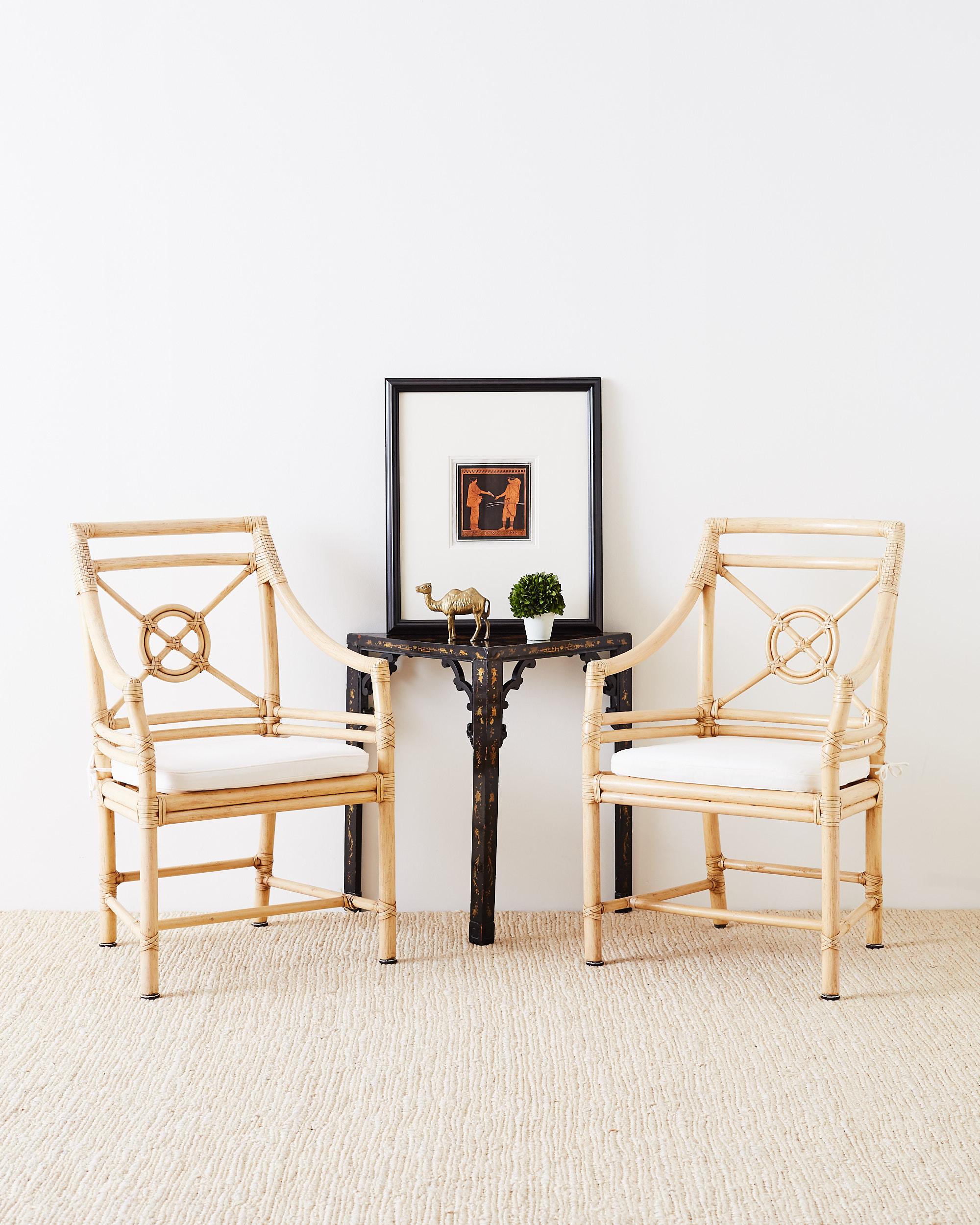 Light blonde pair of bamboo rattan lounge chairs made by McGuire featuring their popular target design backsplat. Constructed with an abundance of leather rawhide strapping in a decorative light color to match blonde finish frames. Soft white seat