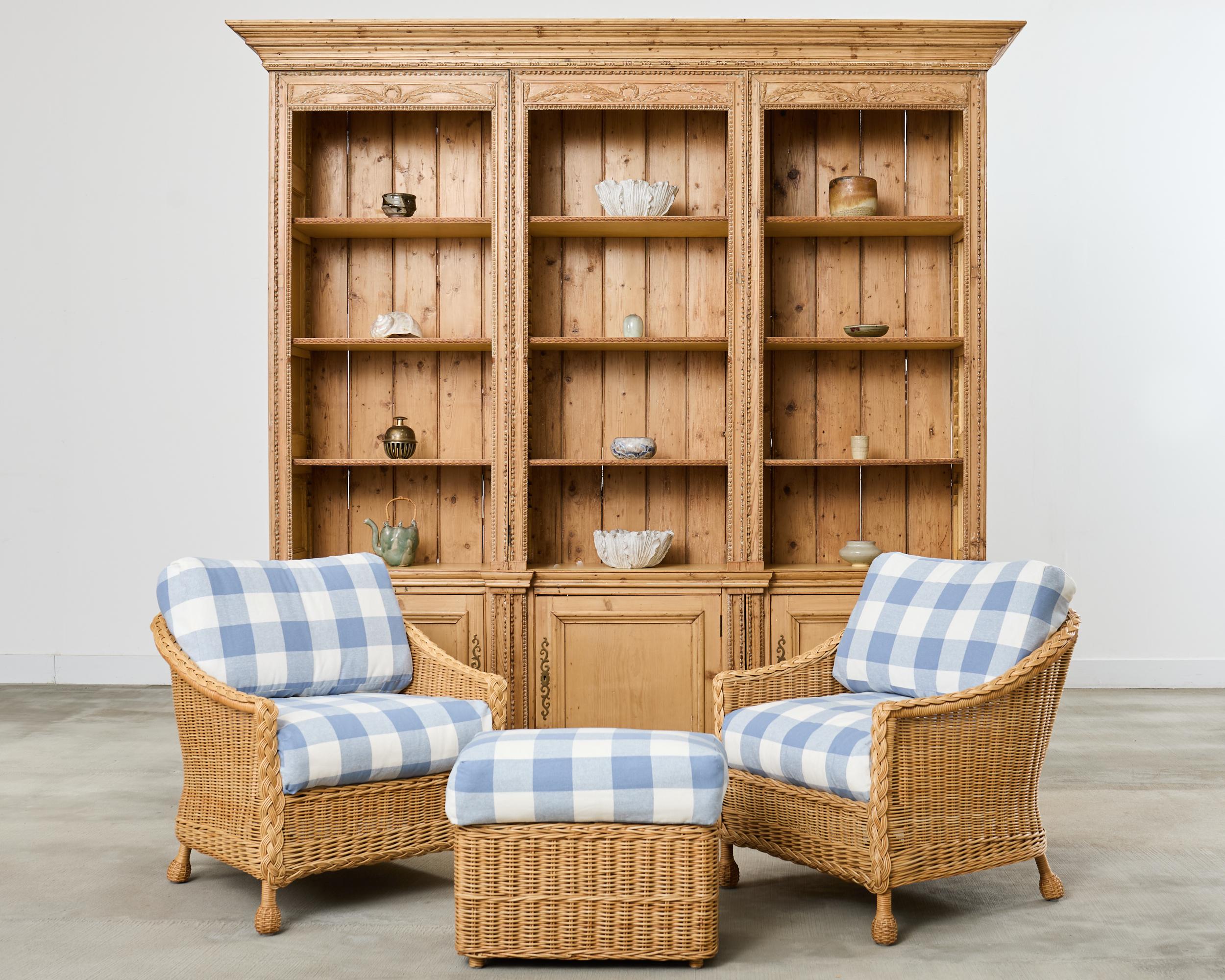 Amazing pair of barrel back form rattan wicker lounge chairs or club chairs made in the California coastal organic modern style by McGuire artisans. The rare chairs feature a strong rattan frame covered with woven wicker. The arms gracefully curve