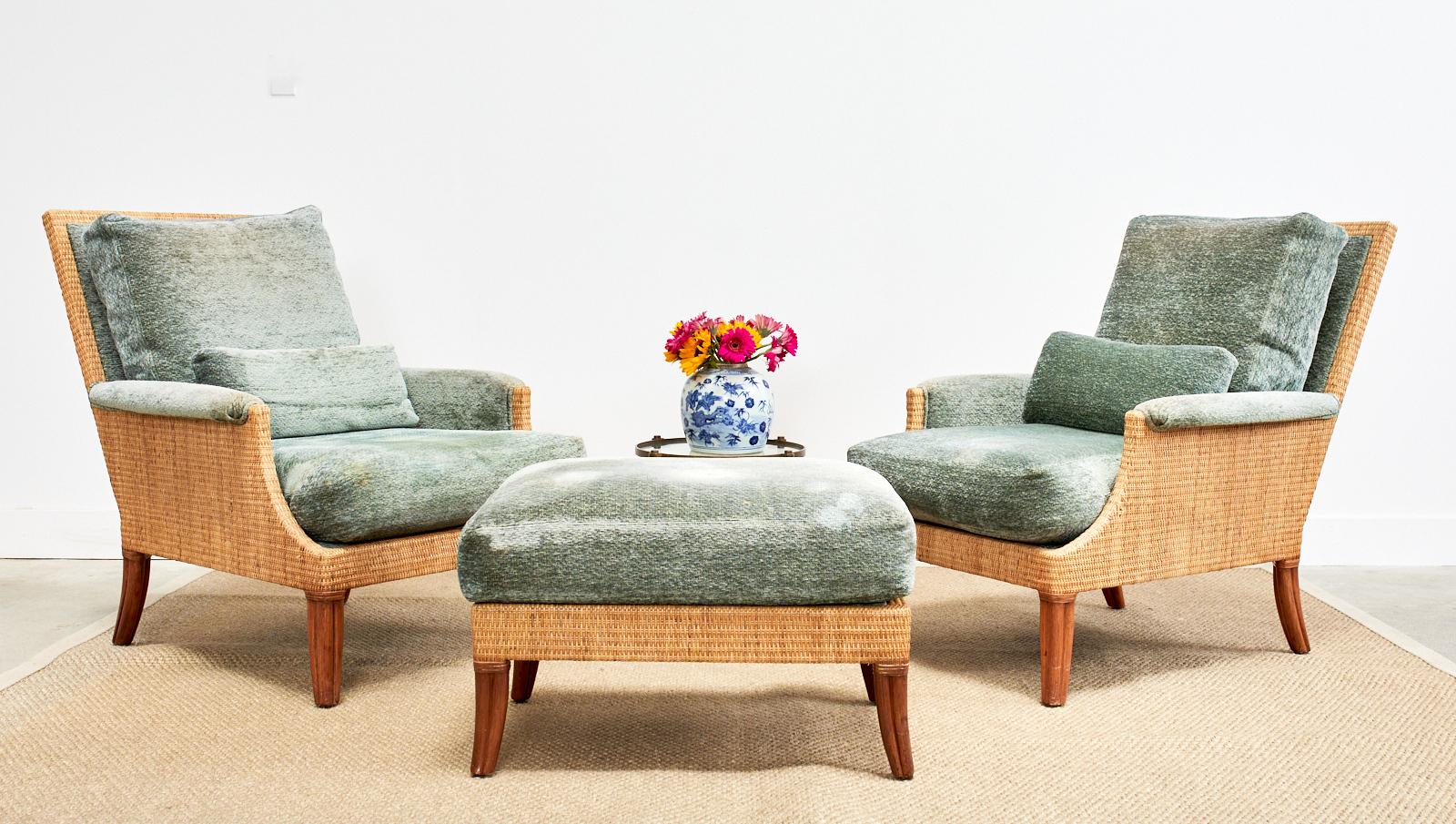 Rare pair of organic modern rattan and wicker oversized lounge chairs designed by Orlando Diaz-Azcuy for McGuire. The set includes two lounge chairs, one ottoman, four thick seat cushions, and two bolster pillows. Known as the Umbria chair it